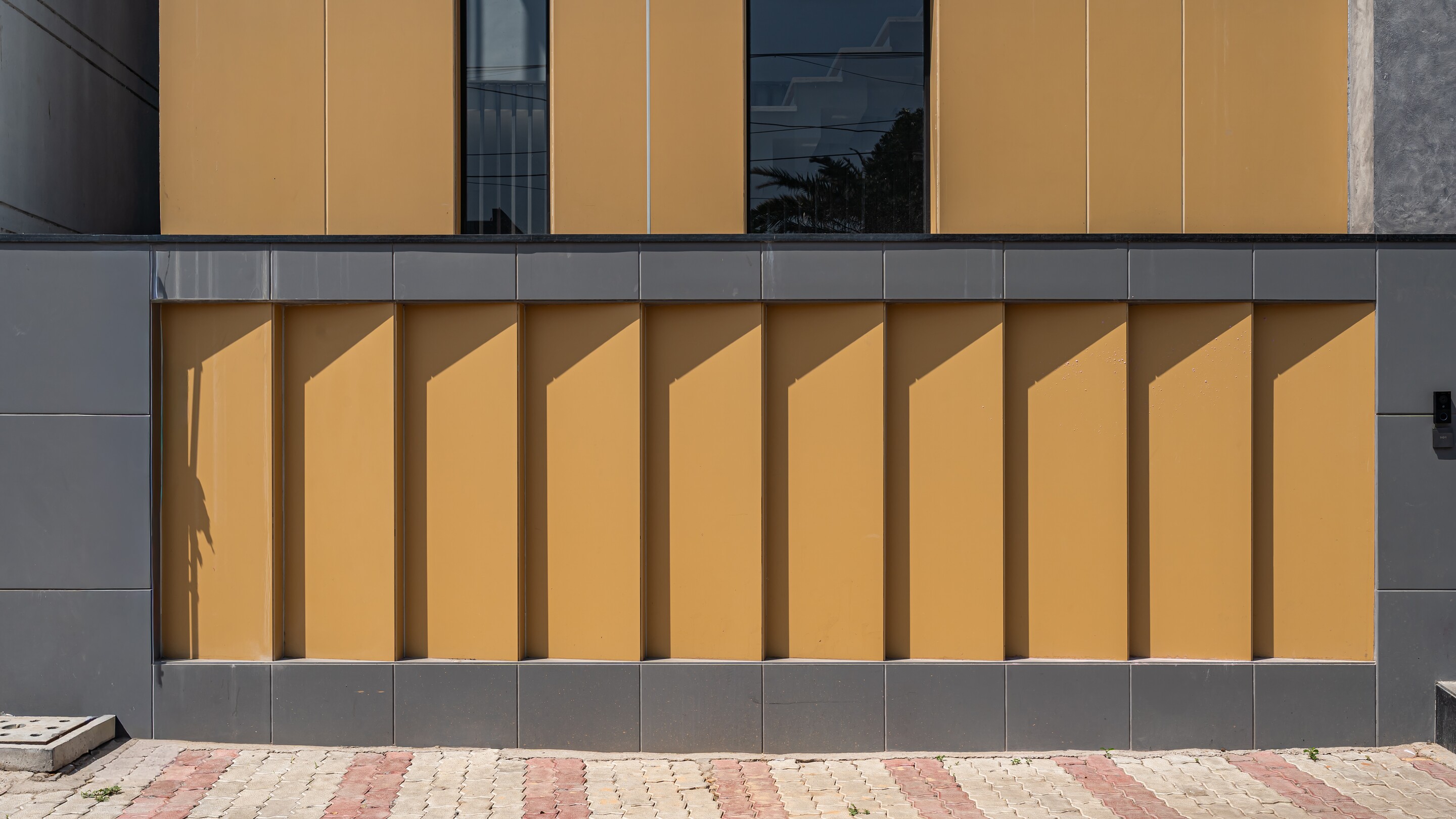Ochre fin panels fold across the facade.