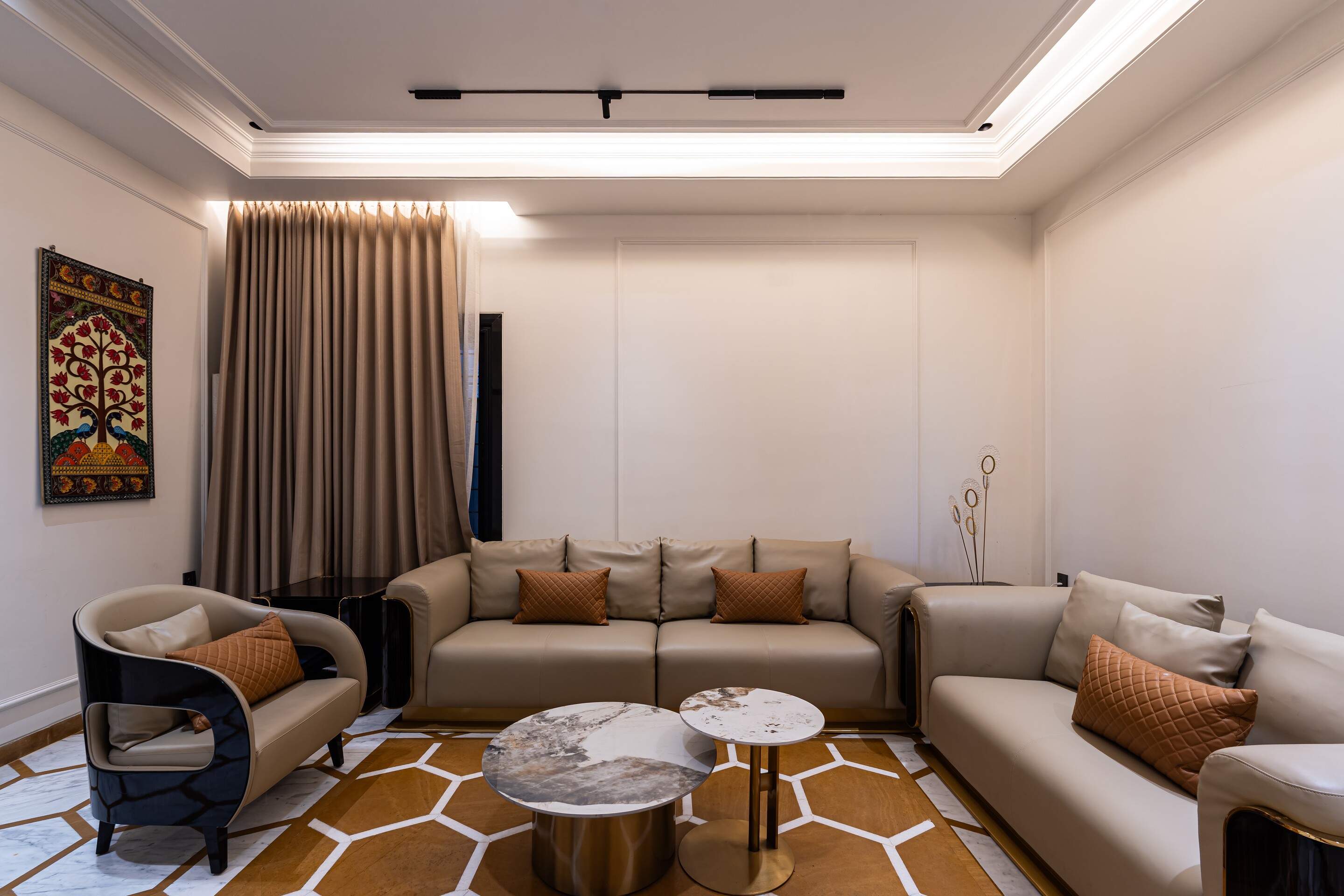 The living room. A hexagon rug under low sofas.