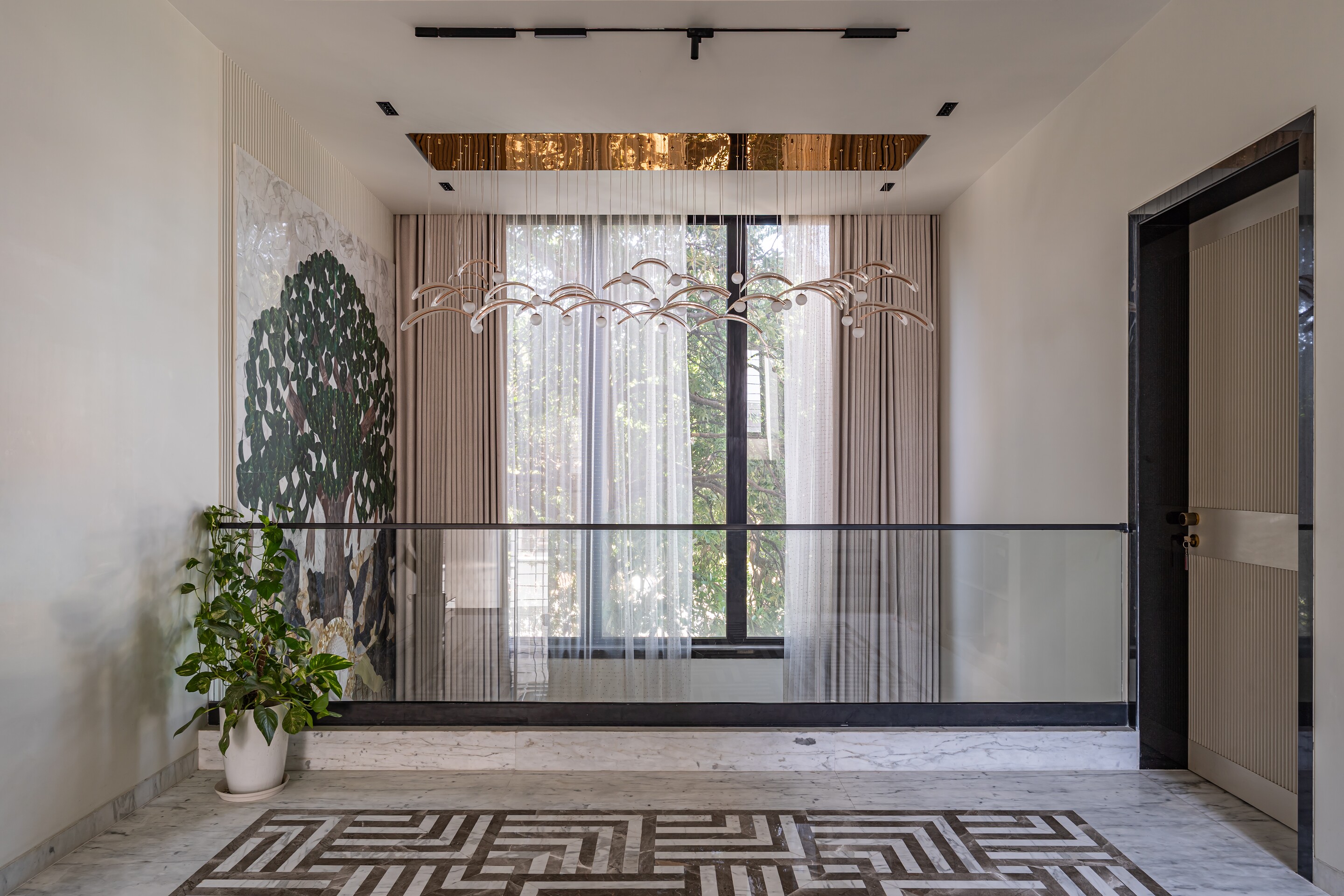 A tree mural and a greek-key floor in the guest suite.