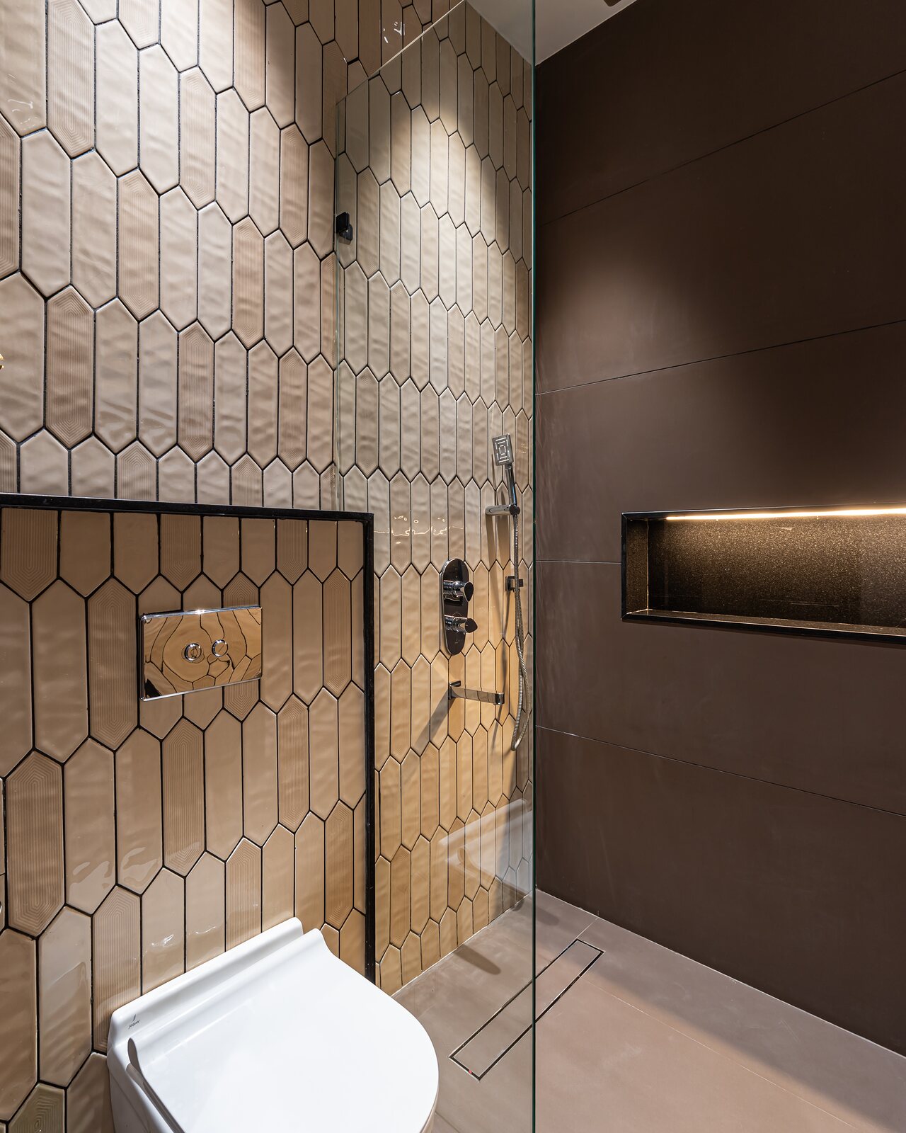 A shower behind hexagon tile.
