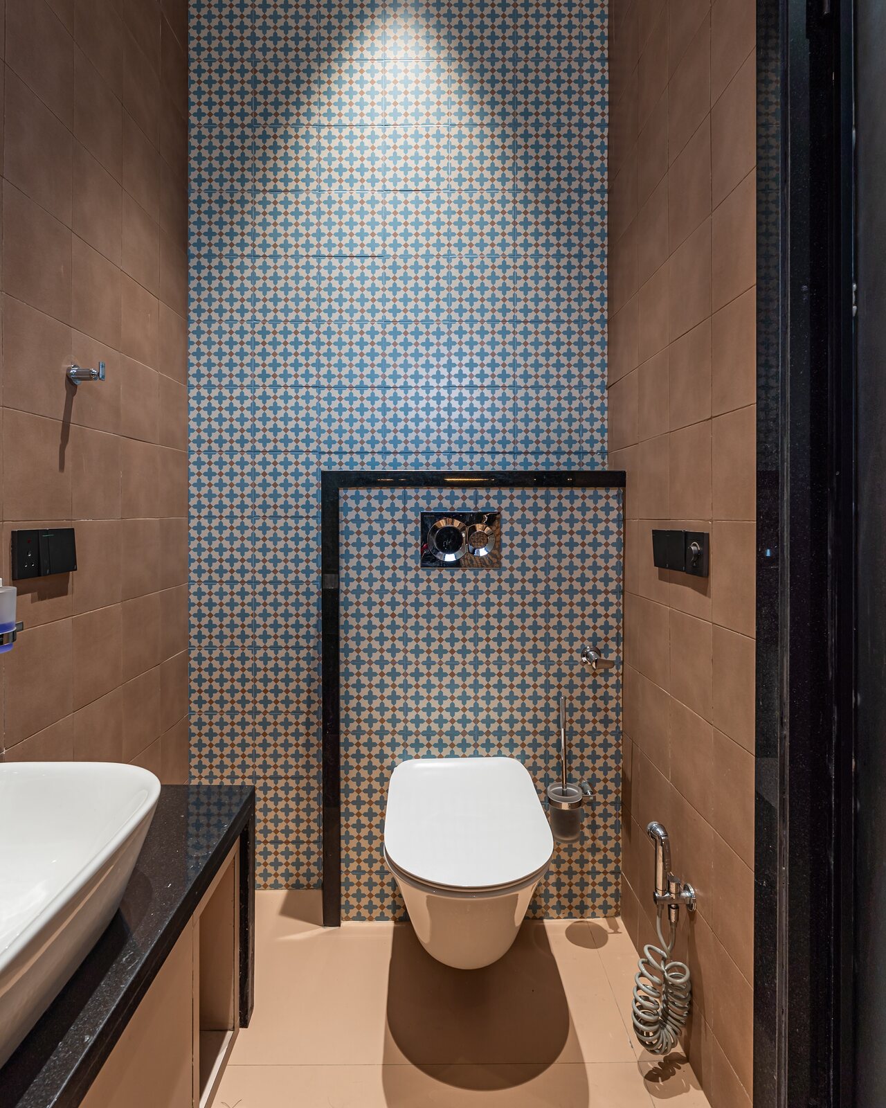 A mosaic-tiled cloakroom.