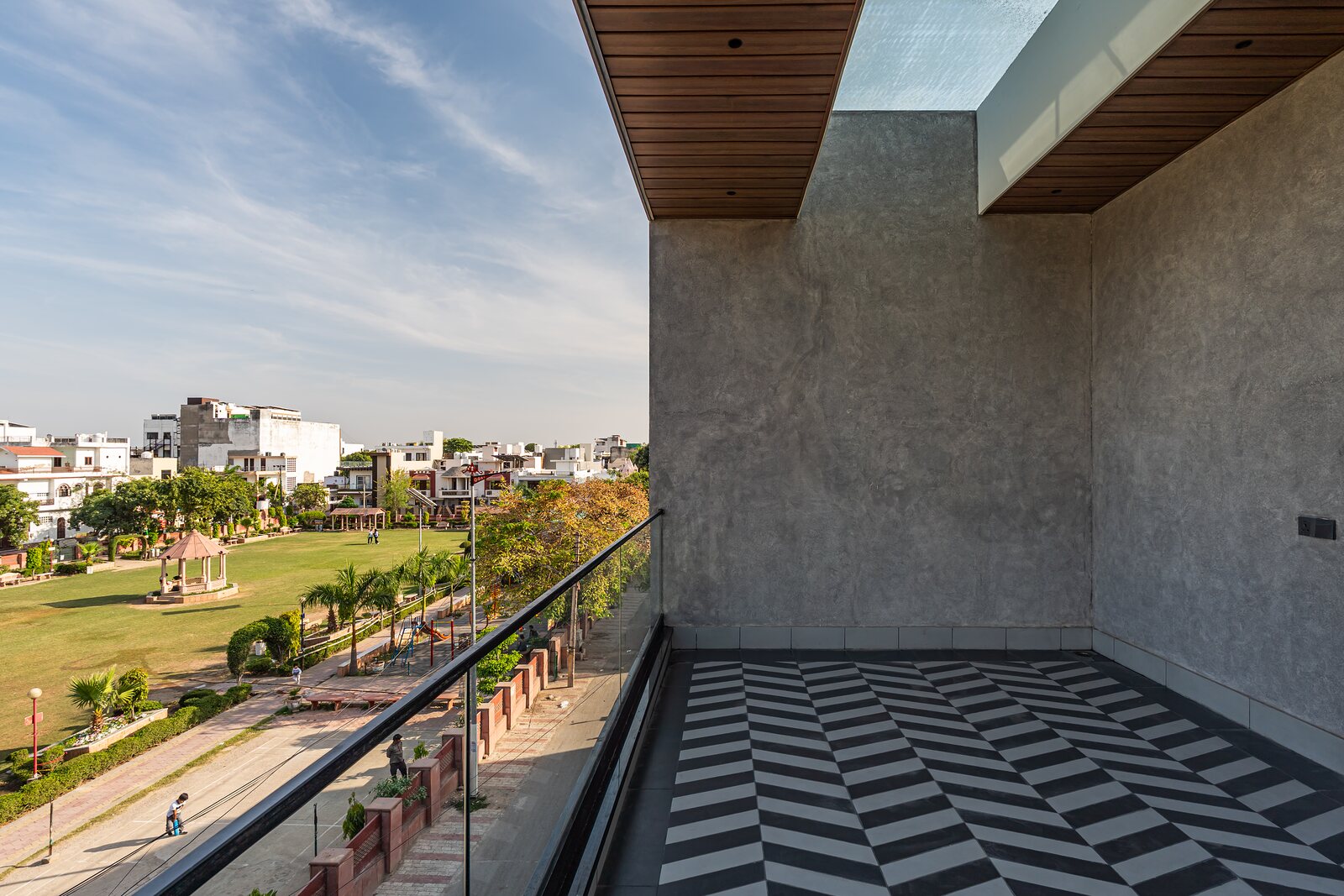 The striped terrace opens to the city.