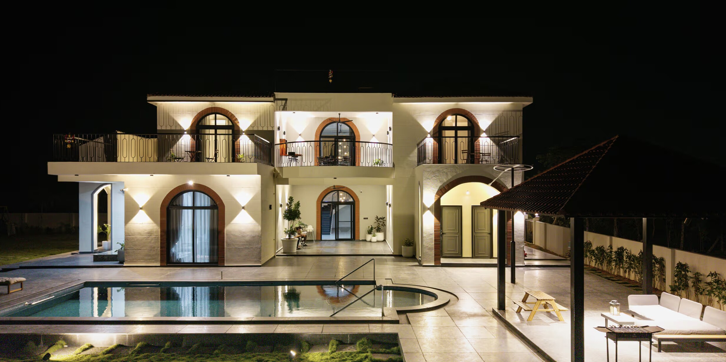 The pool and facade after dark.