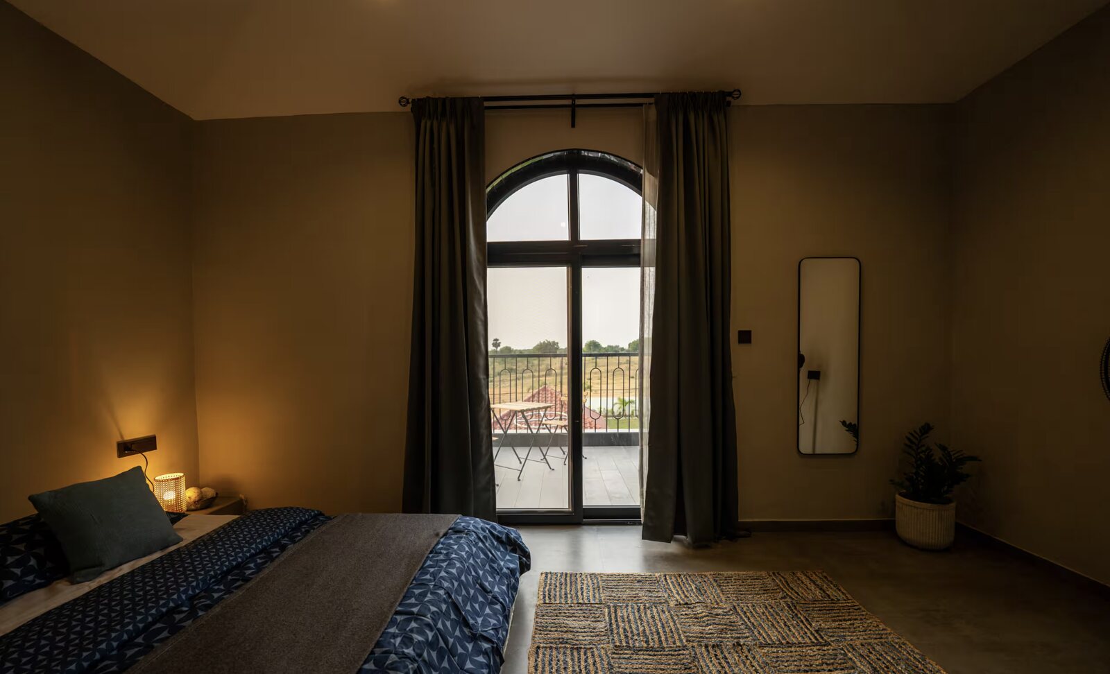 A bedroom, an arched window onto the fields.