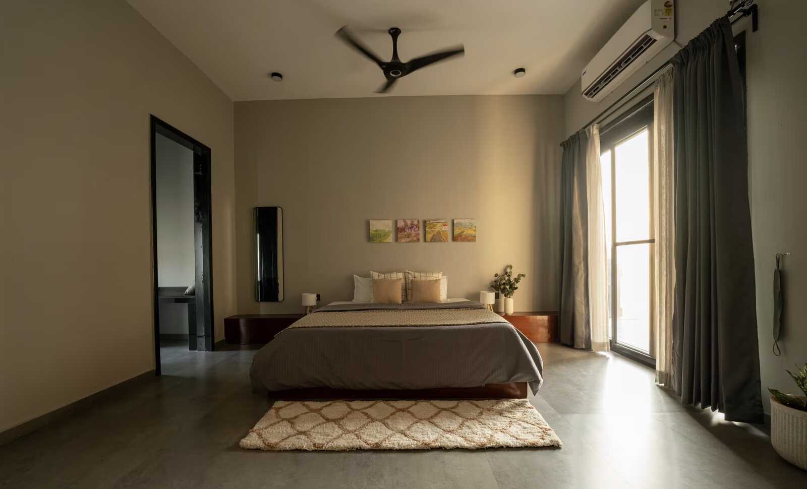 A bedroom in warm neutral tones.