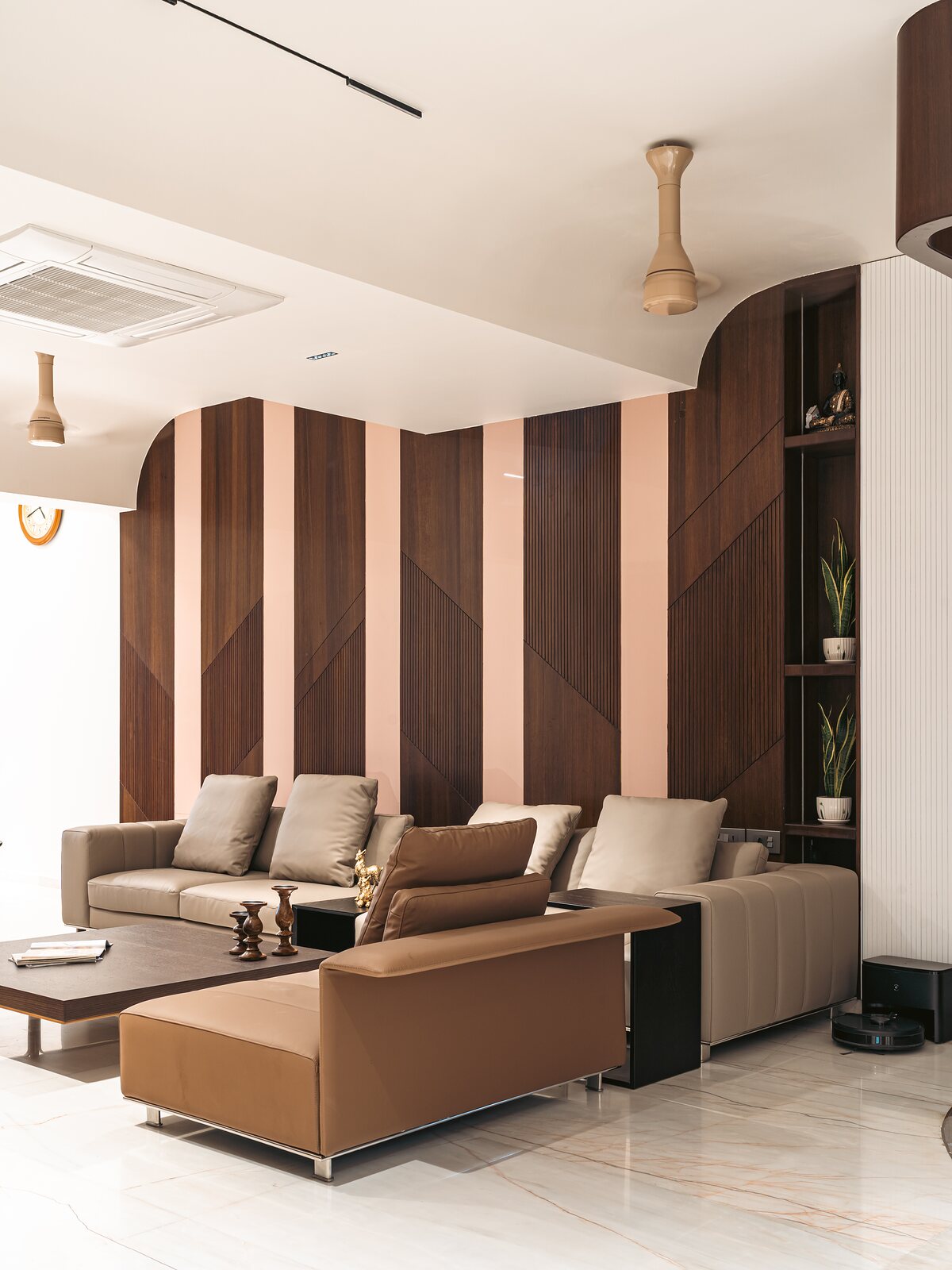 Deep sofas between striped timber screens.