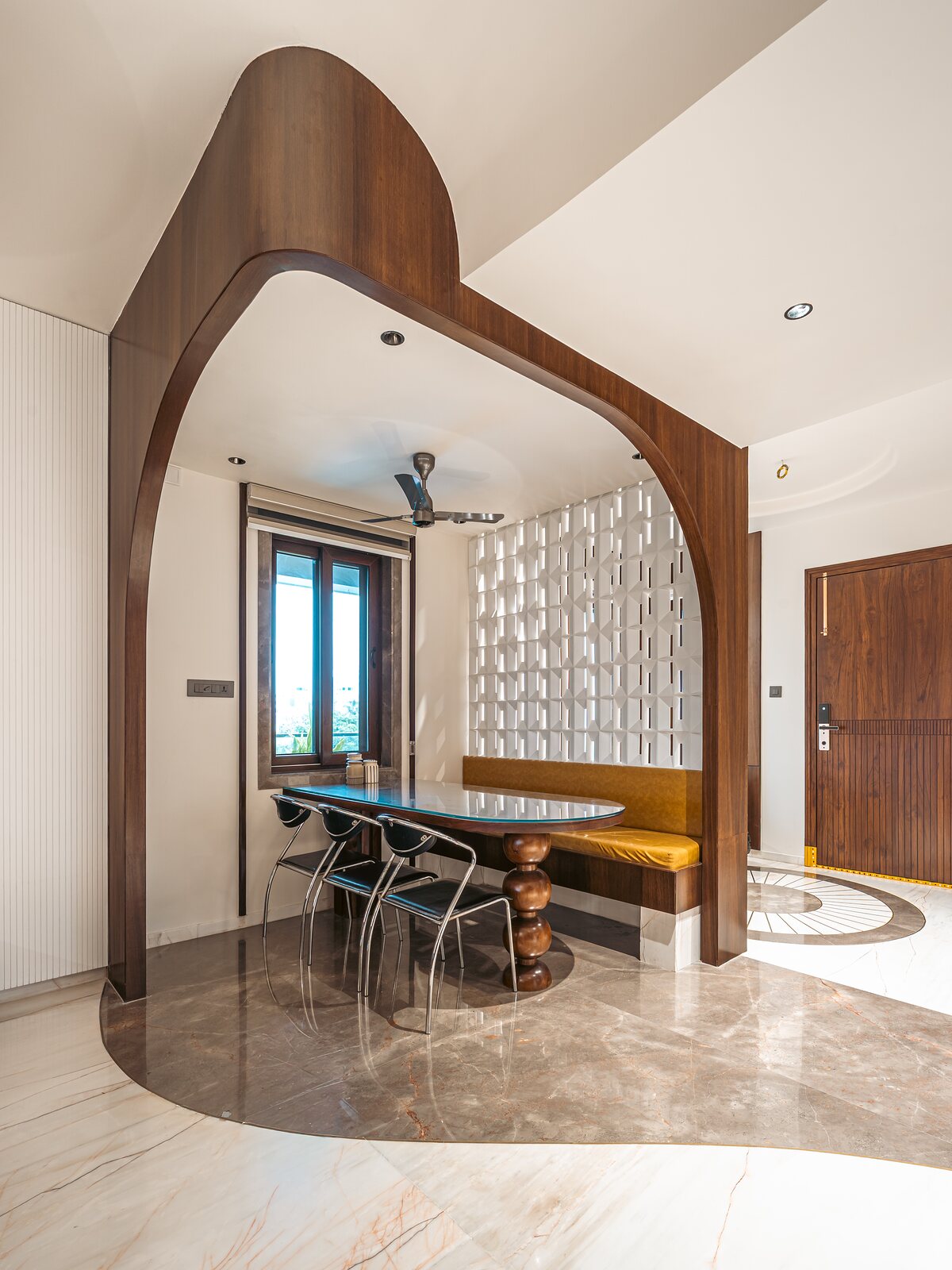 The dining room, framed by a curved timber arch.