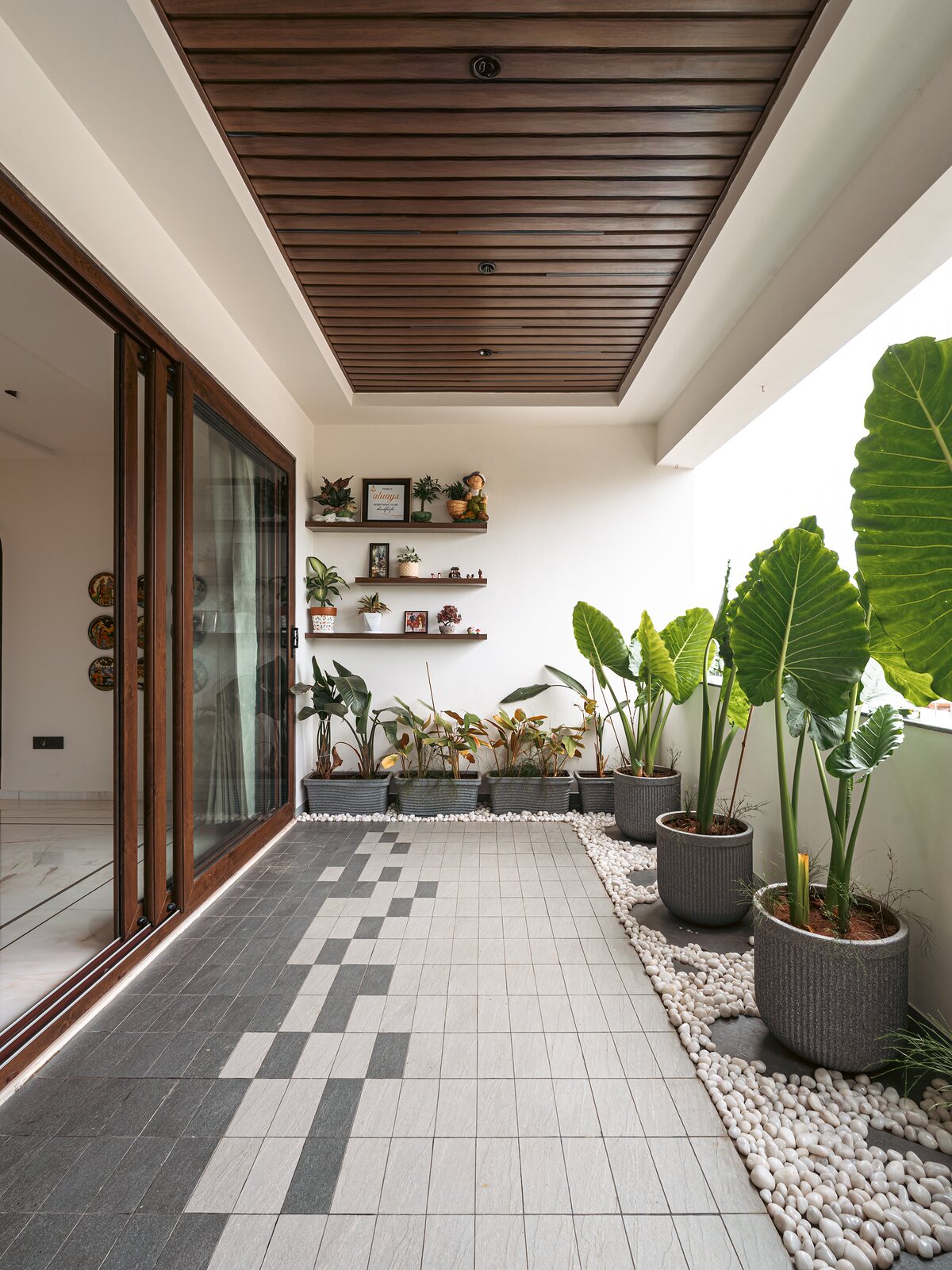 The courtyard. Potted palms on a patterned stone floor.
