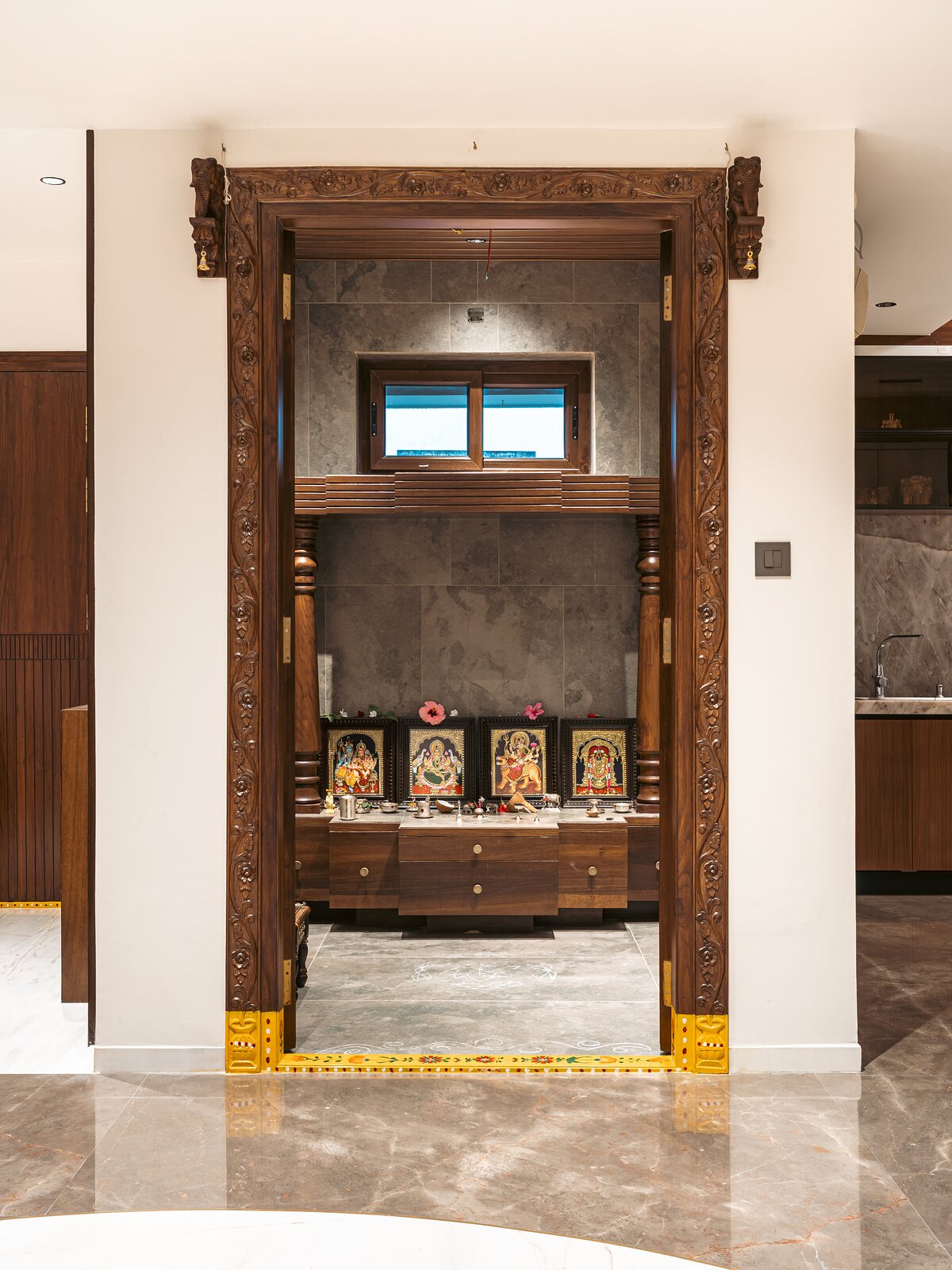 The pooja room, an open mandir in carved teak.