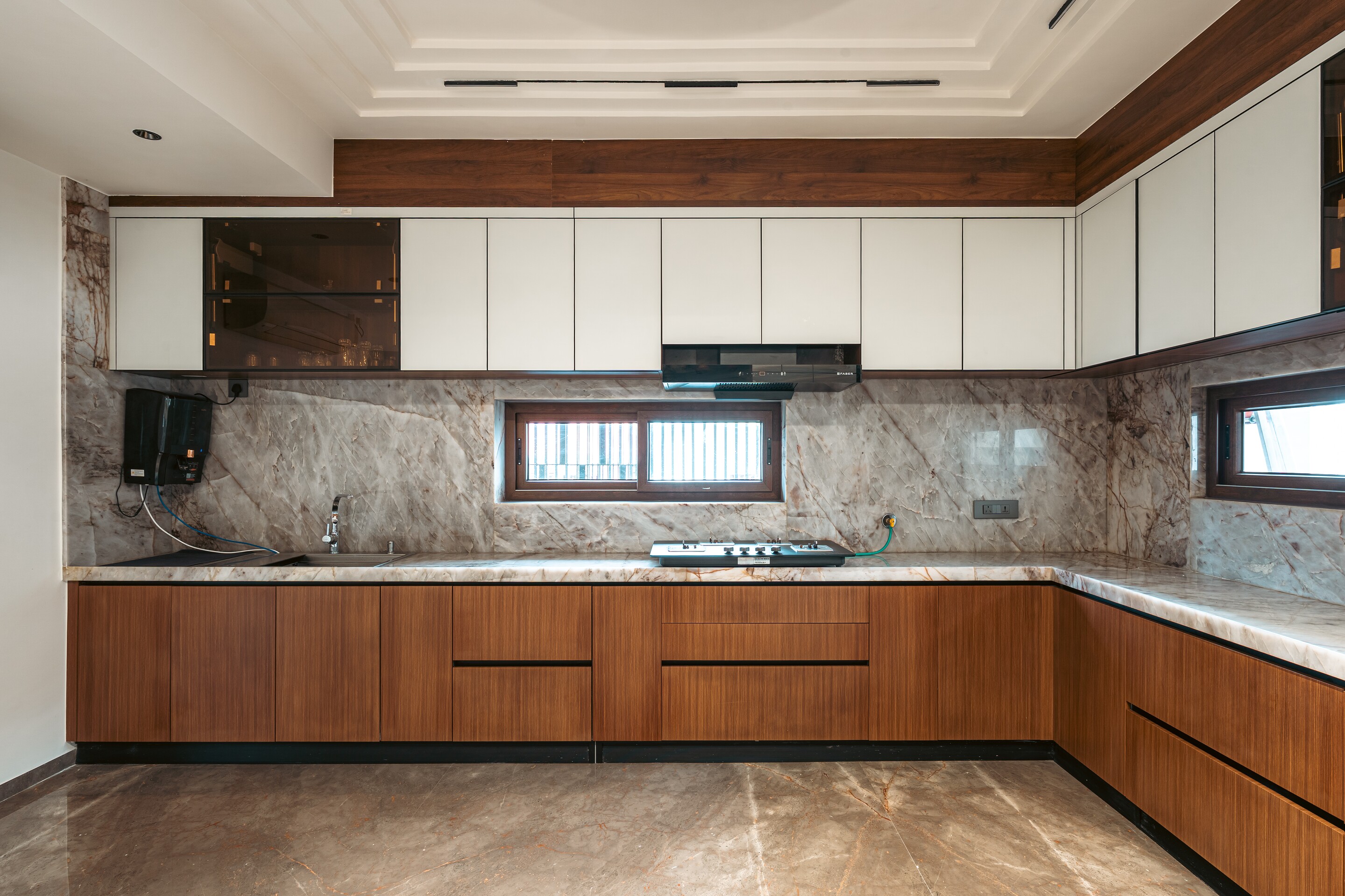 The kitchen. Marble and timber under white cabinets.