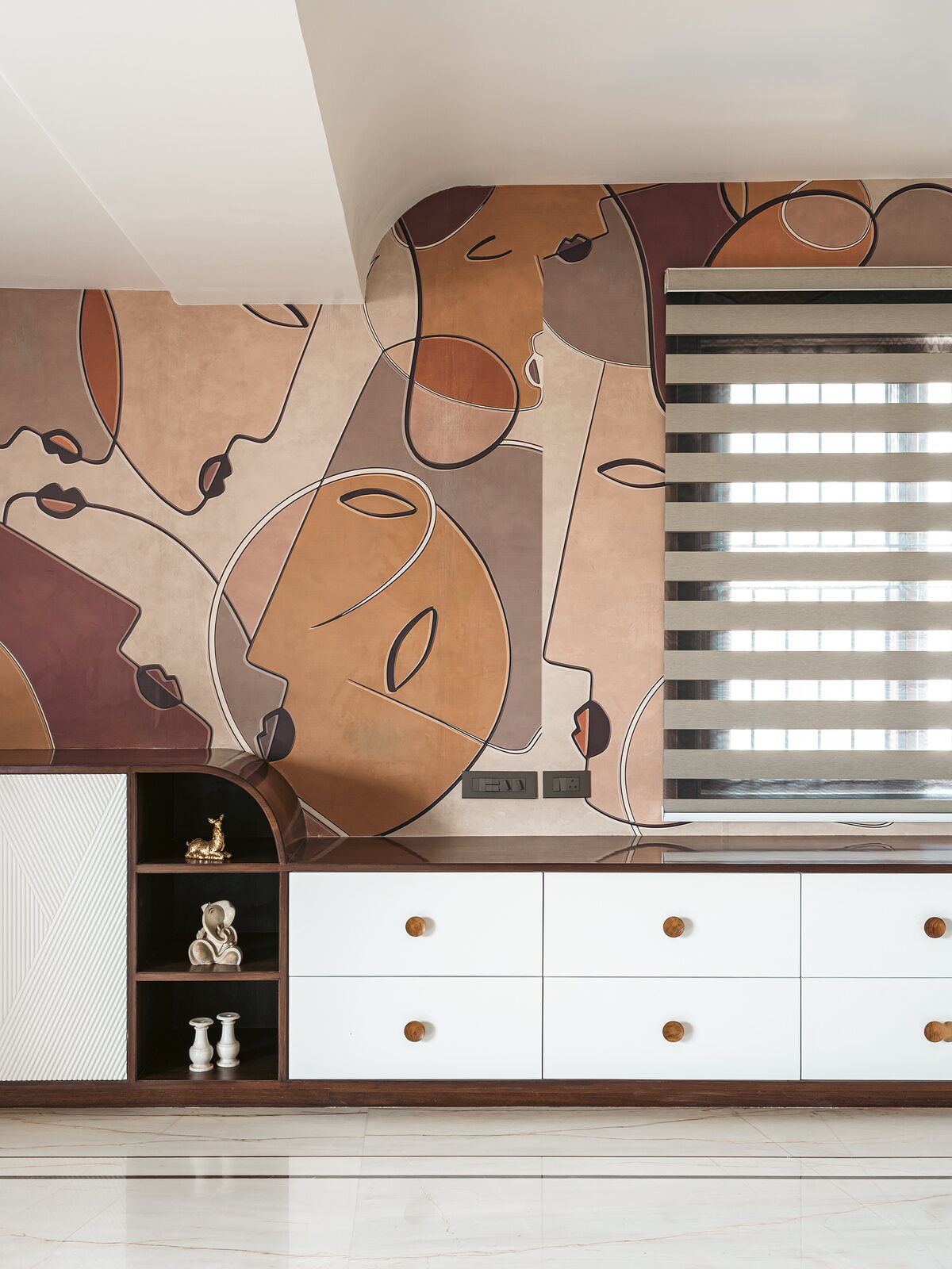 A dressing counter below an abstract mural.