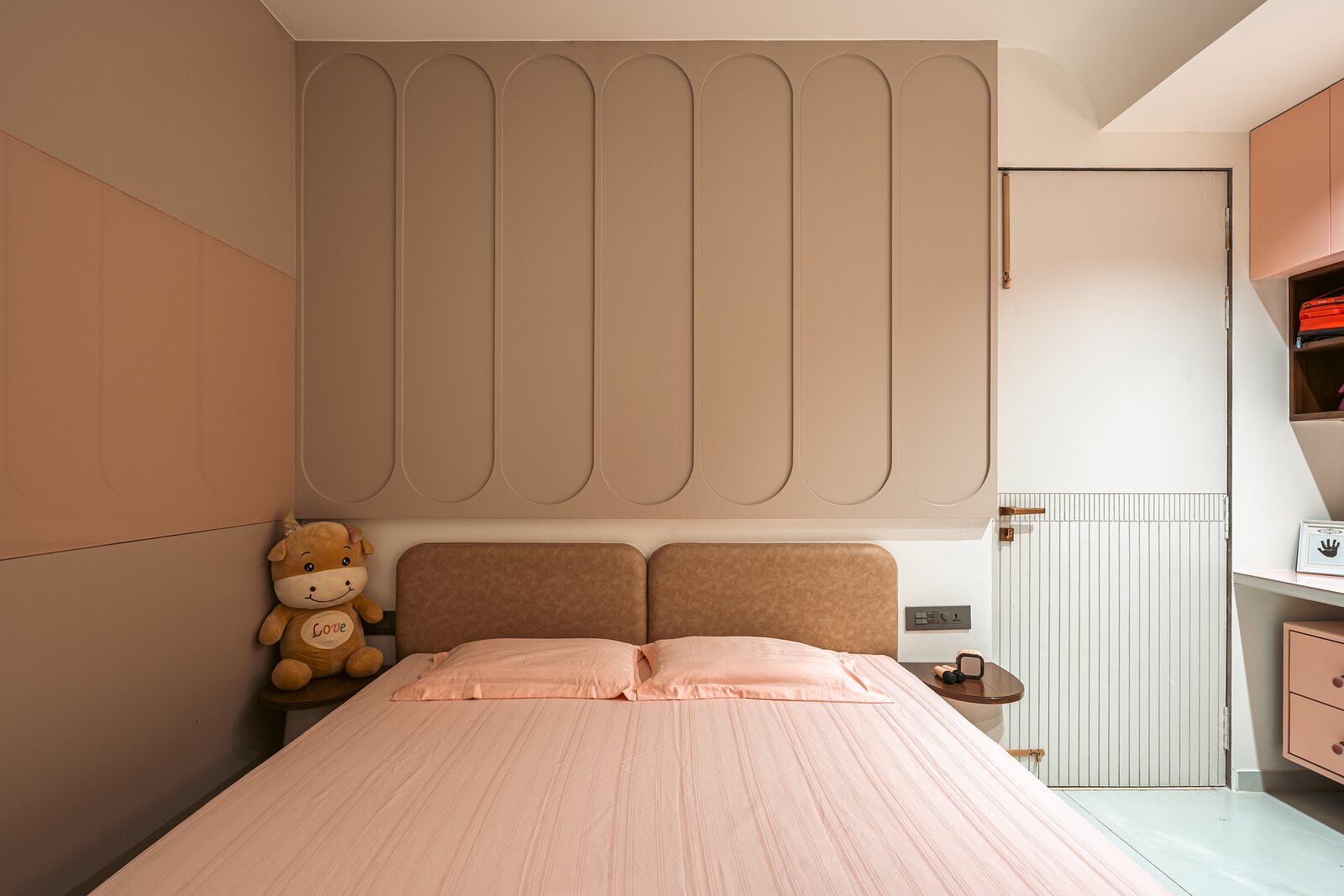 A bedroom panelled in soft peach.