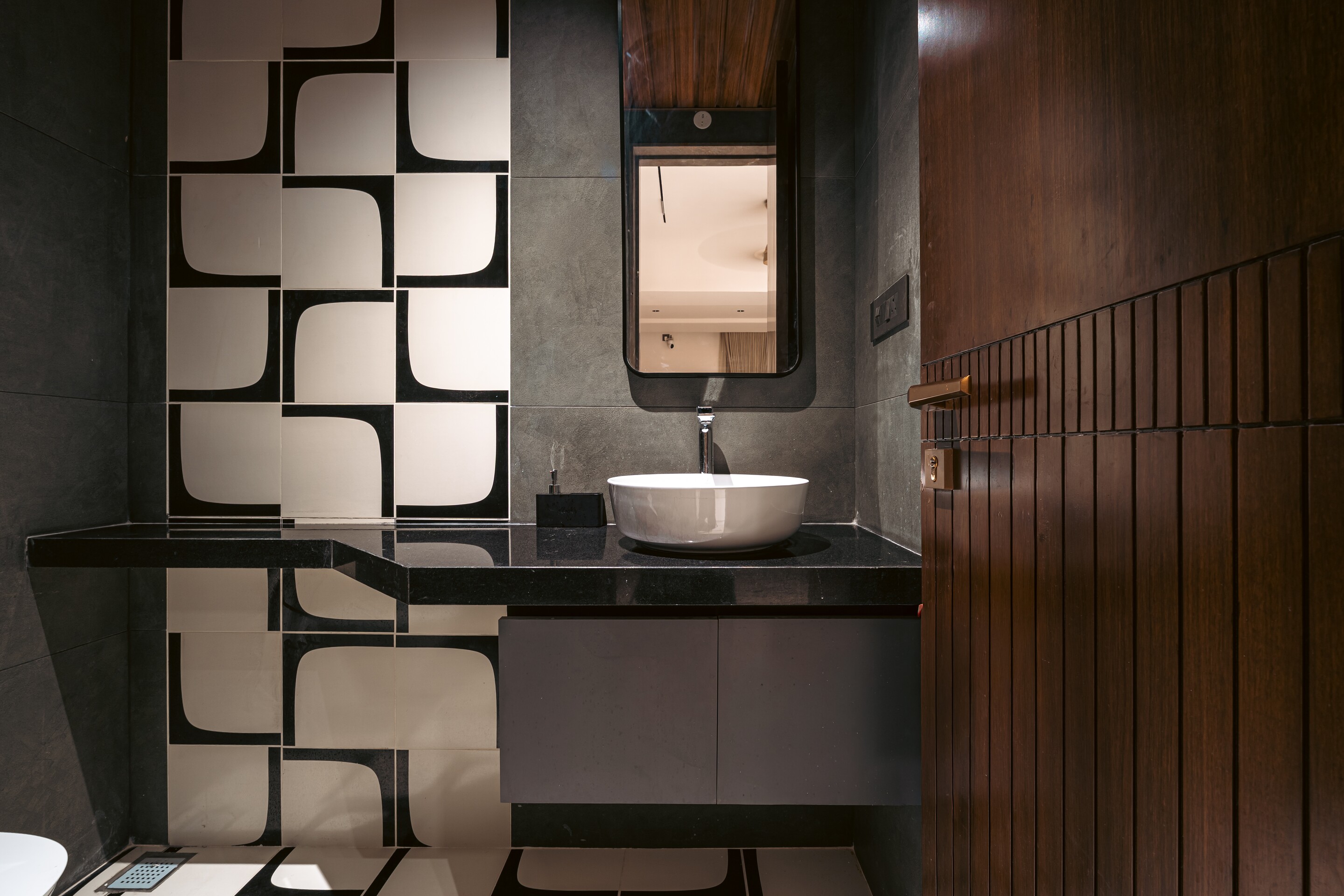 A vessel basin against the puzzle-tile wall.