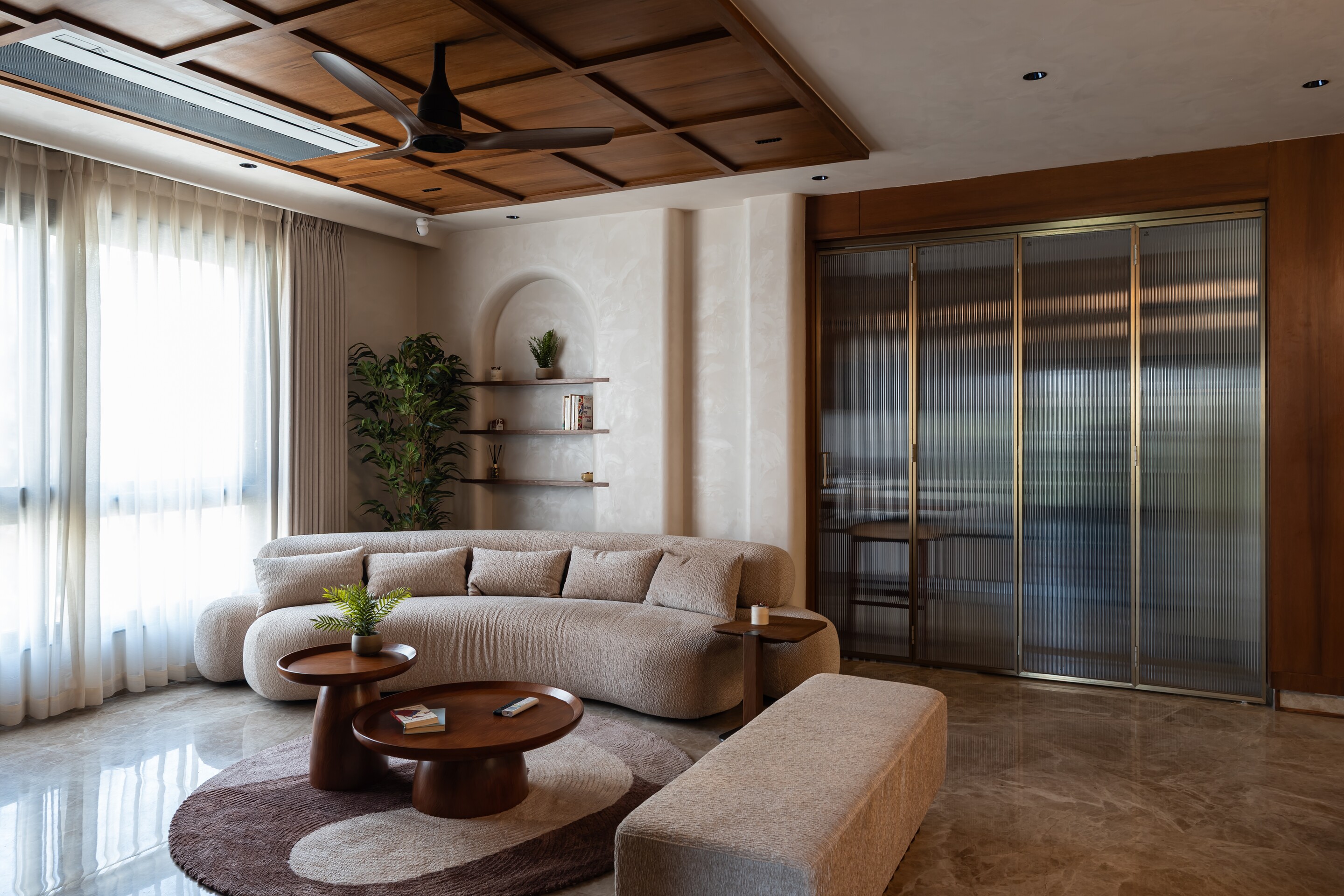 The curved sofa faces the garden windows.