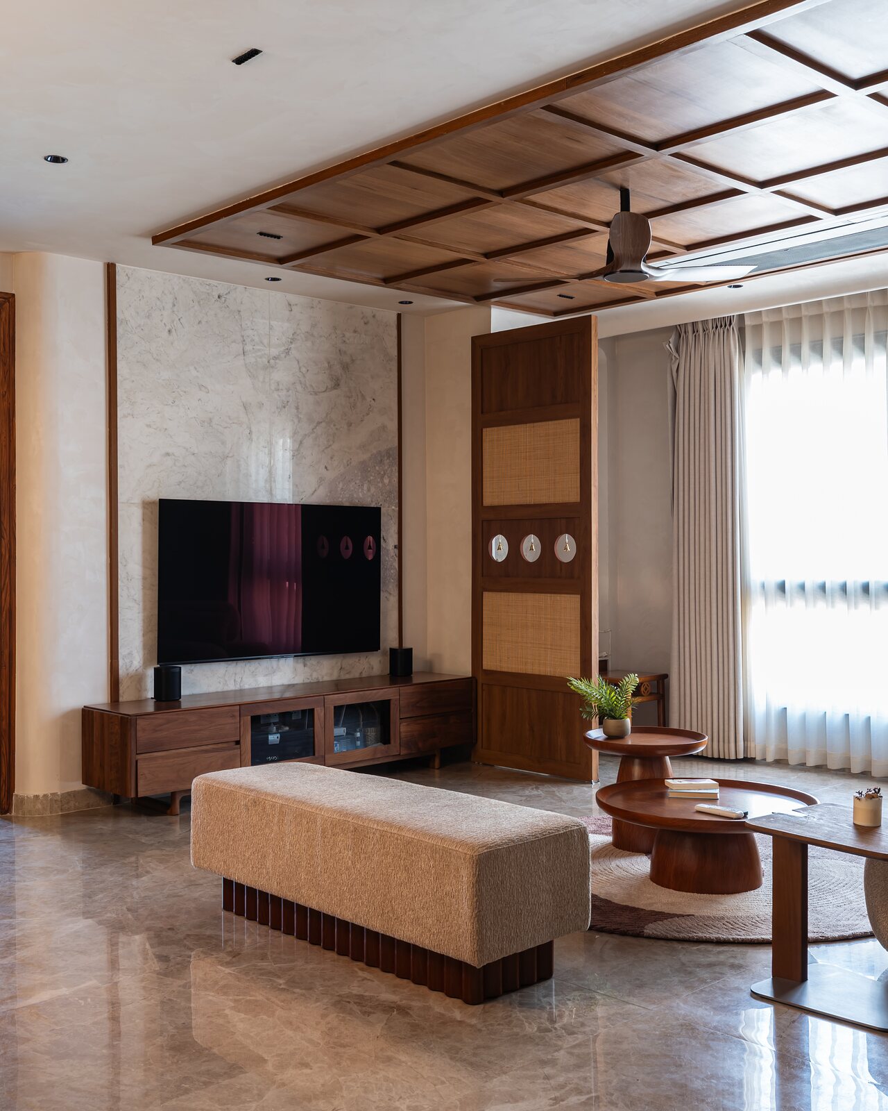 The room runs long under the coffered ceiling.