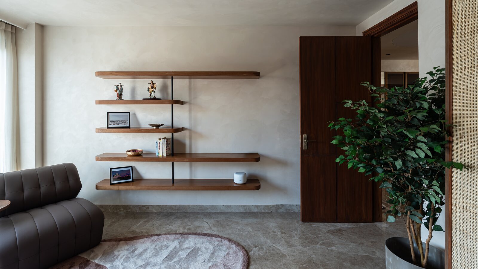 A sitting nook, walnut floating shelves beside the door.