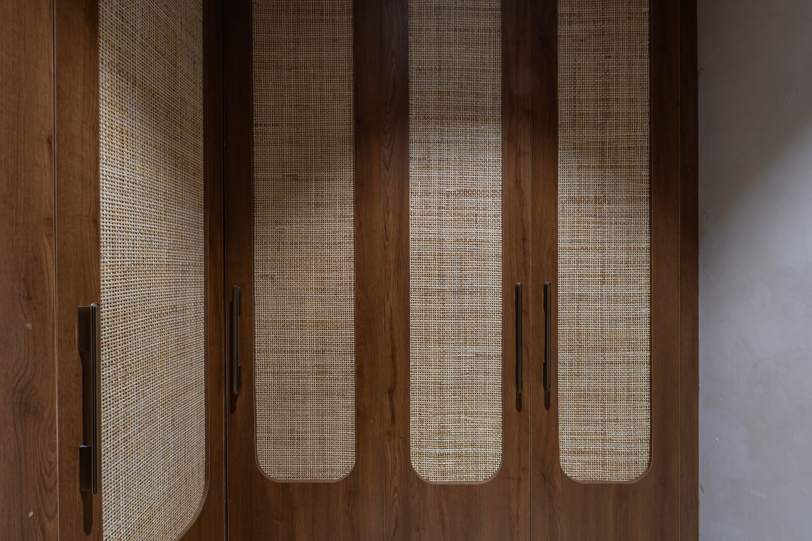 Cane panels set into walnut, up close.