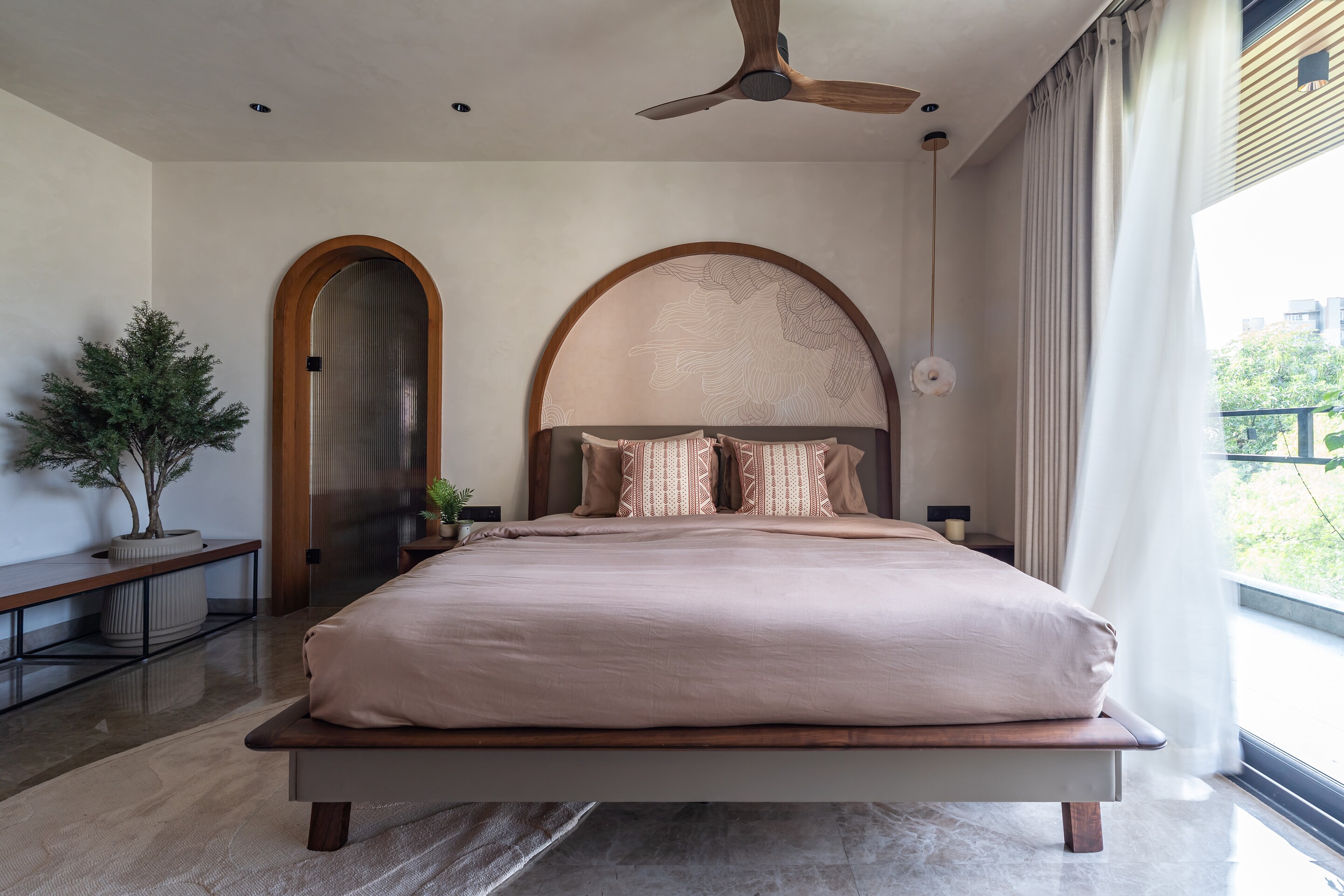 The master suite below its arched headboard.