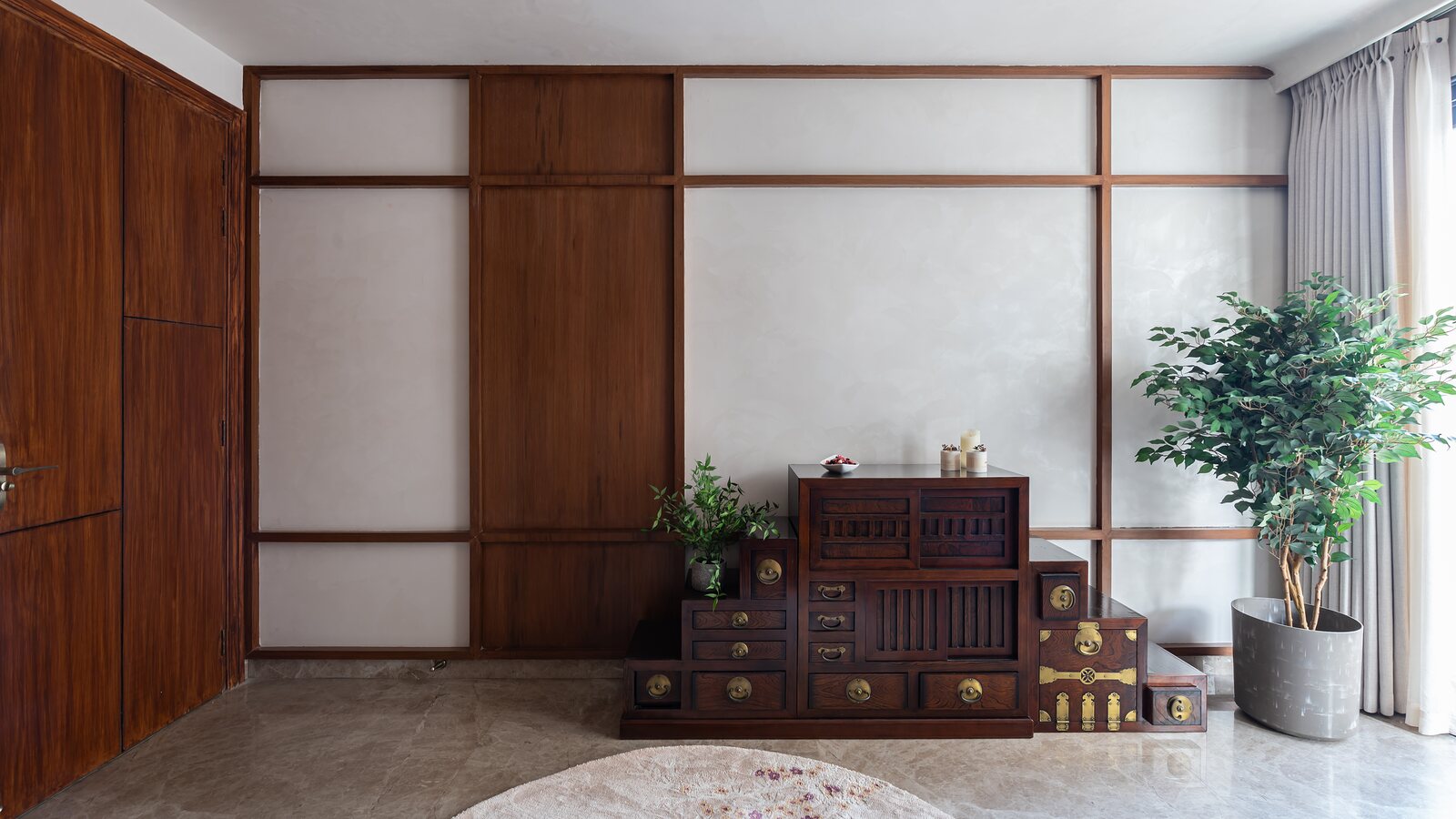The walnut grid wall, panels of plaster and timber.