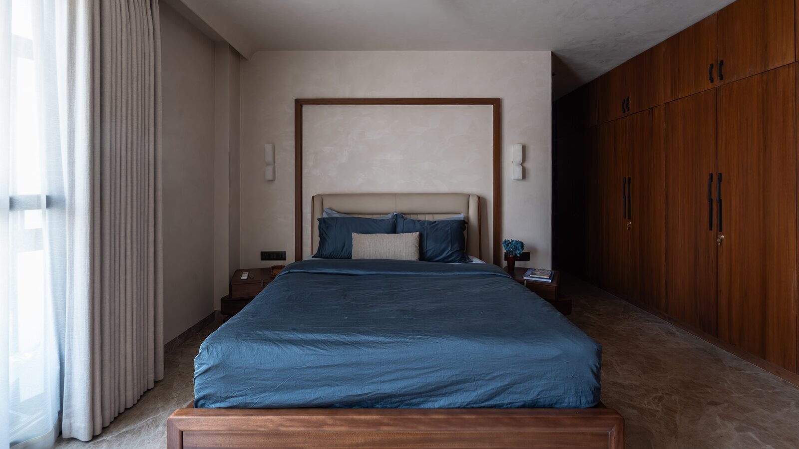 A guest room in indigo and walnut.