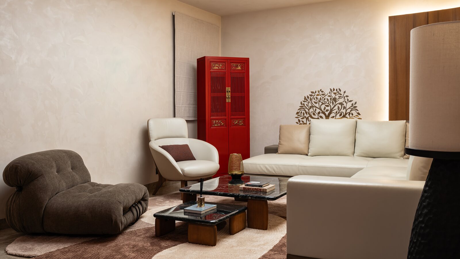 The family lounge, white sofas and a red lacquer cabinet.