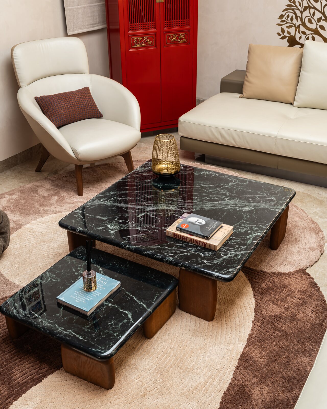 Marble coffee tables on an organic rug.