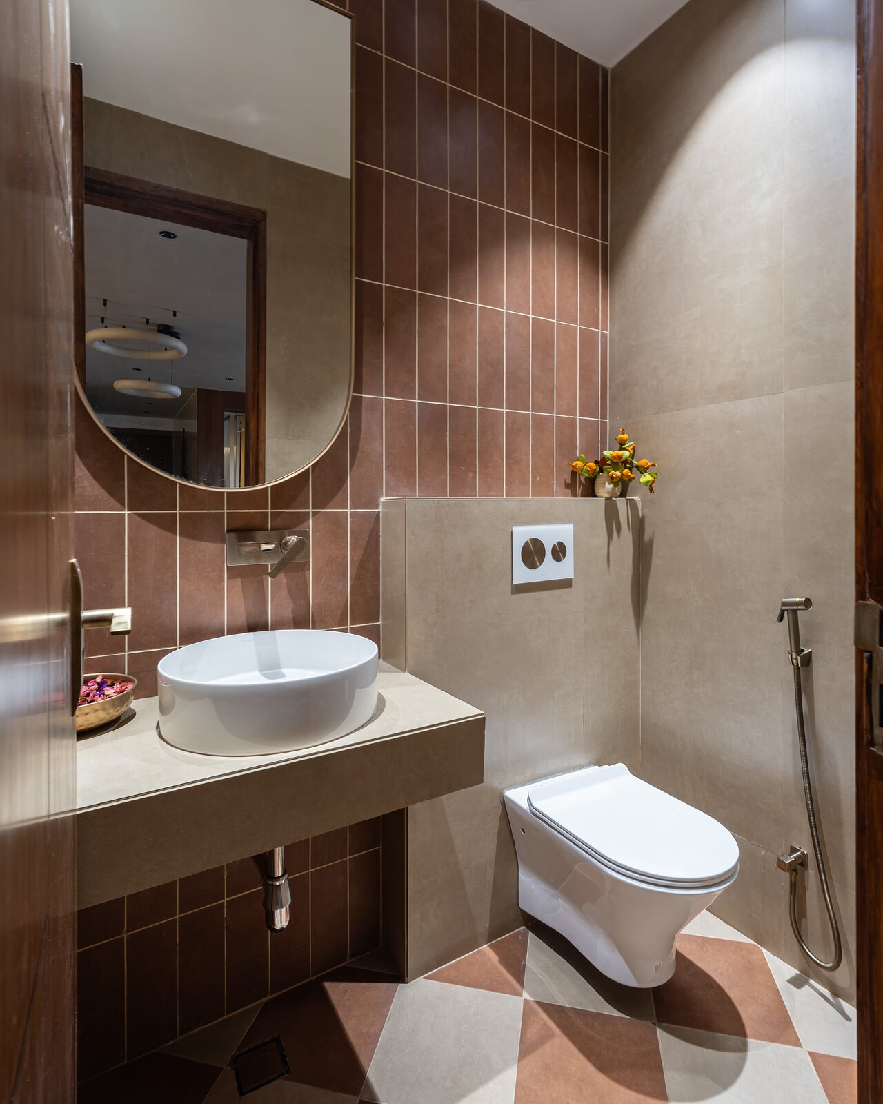 A bathroom in brown tile with a vessel basin.