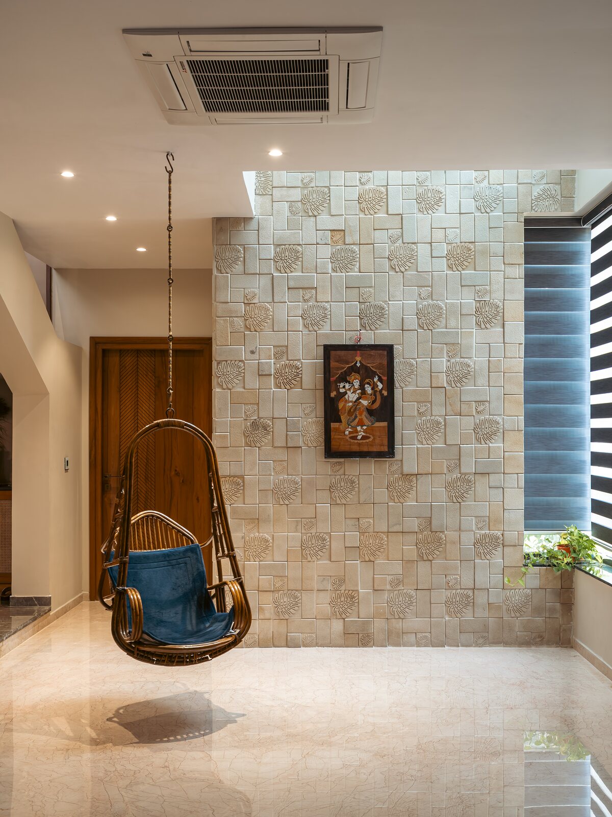 A hanging cane chair against the stone wall.