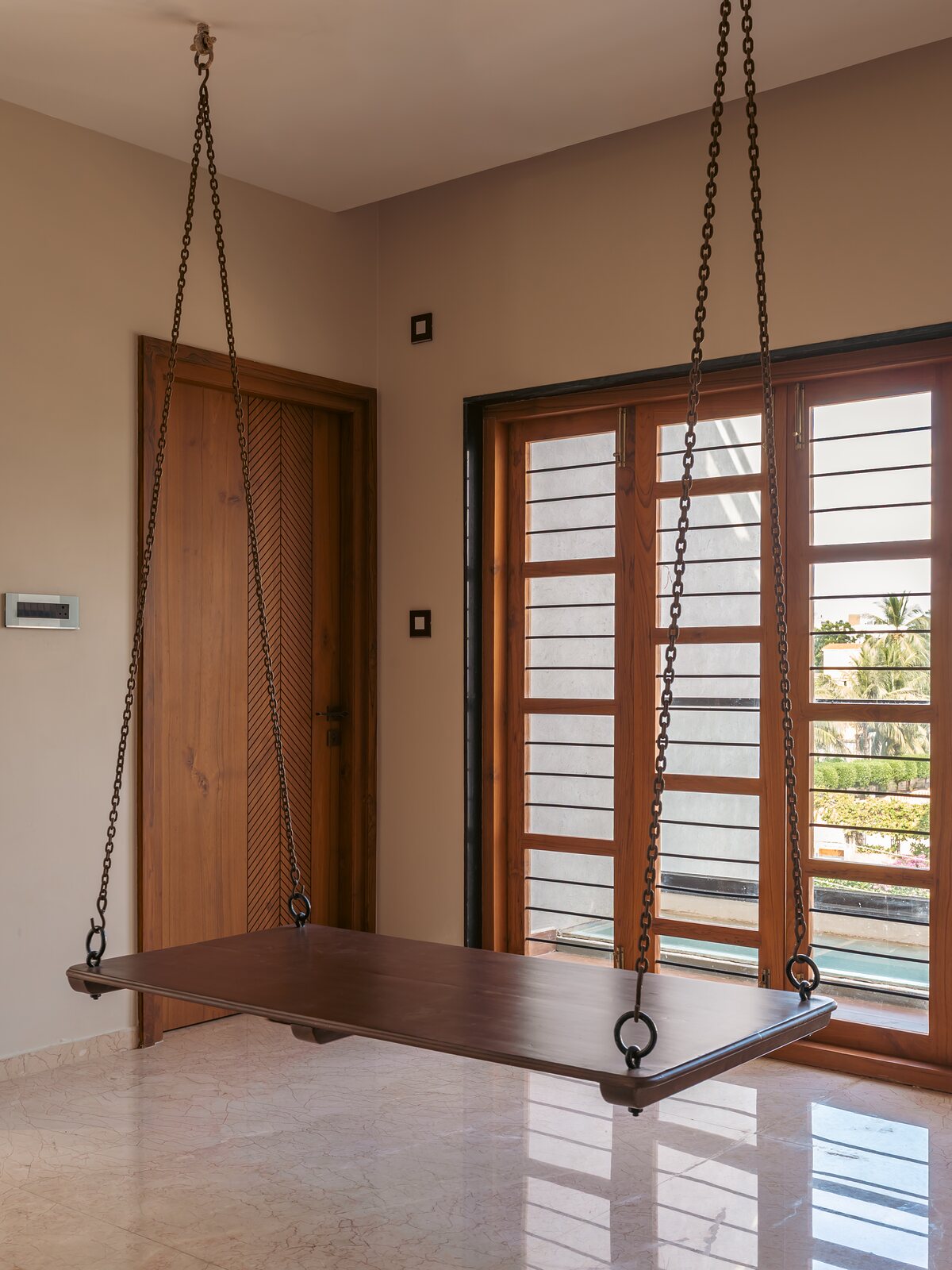A timber swing bench faces the garden.