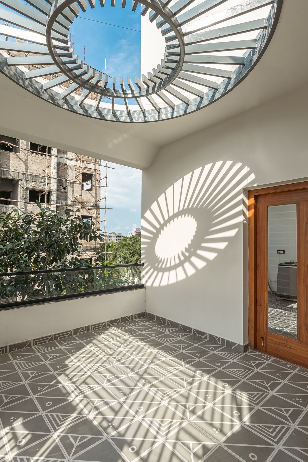 Sunlight from the oculus falls across the floor.