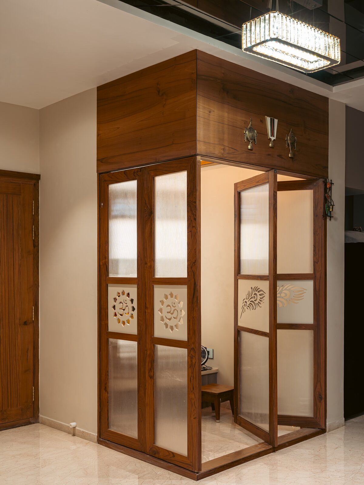 A cabinet framed and carved in teak.