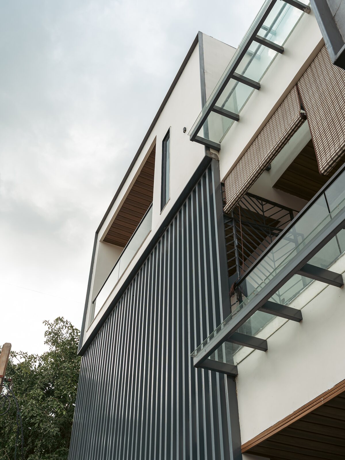 Angular metal cladding at the upper floors.