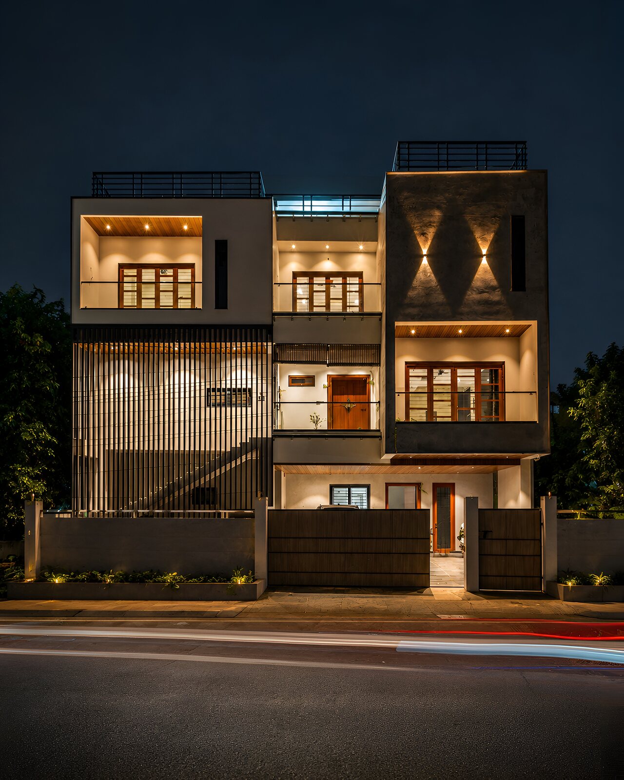 The same elevation after dark, every floor lit.