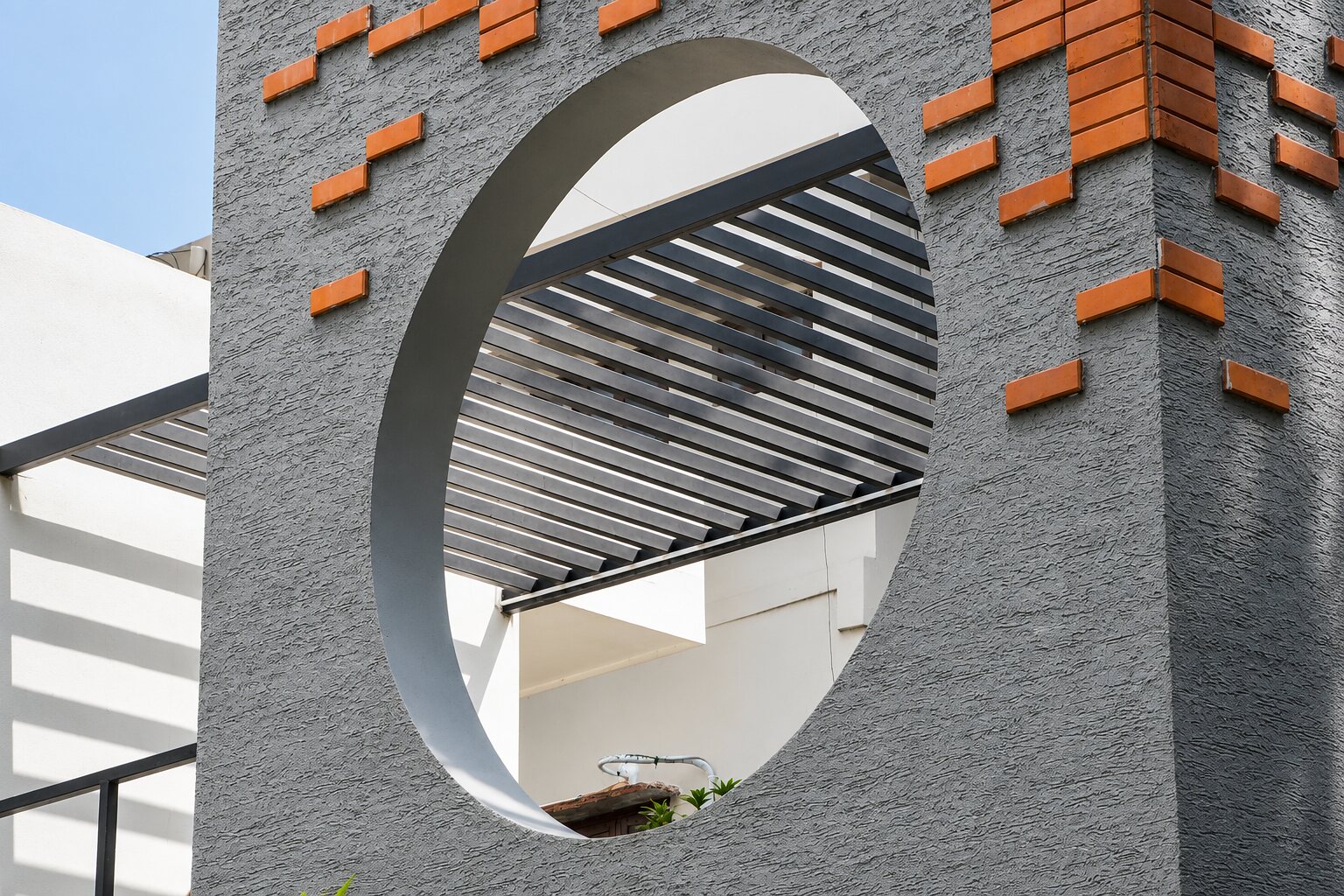 A circular opening cut into the grey wall.