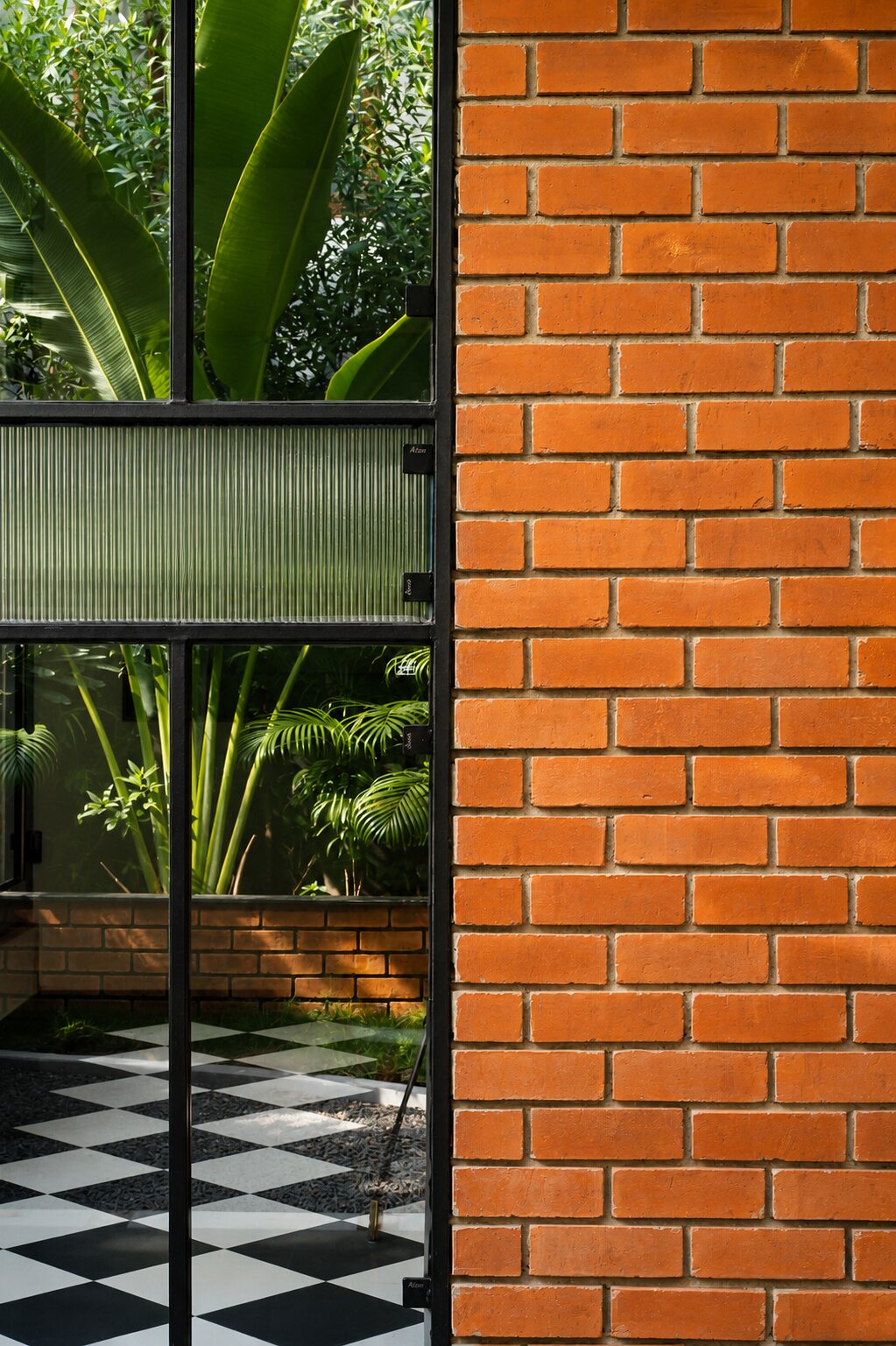 Brick, checkerboard tile and glass, up close.