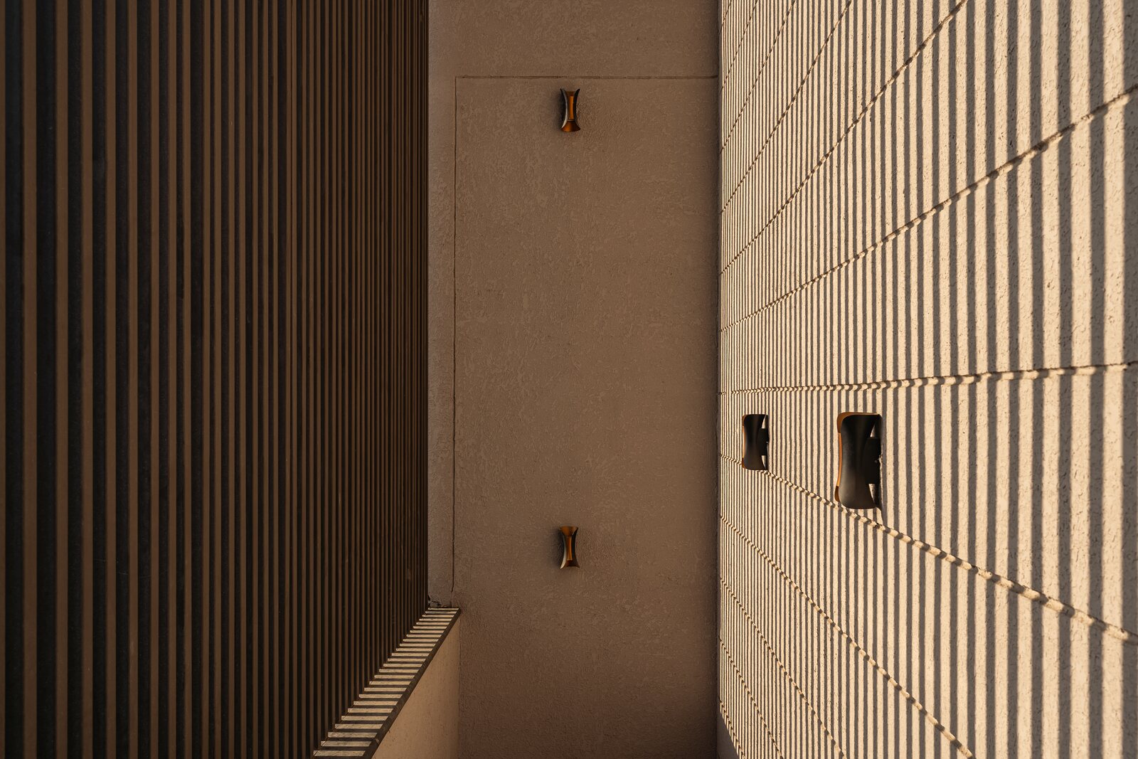 Vertical stone fins screen the side stair.