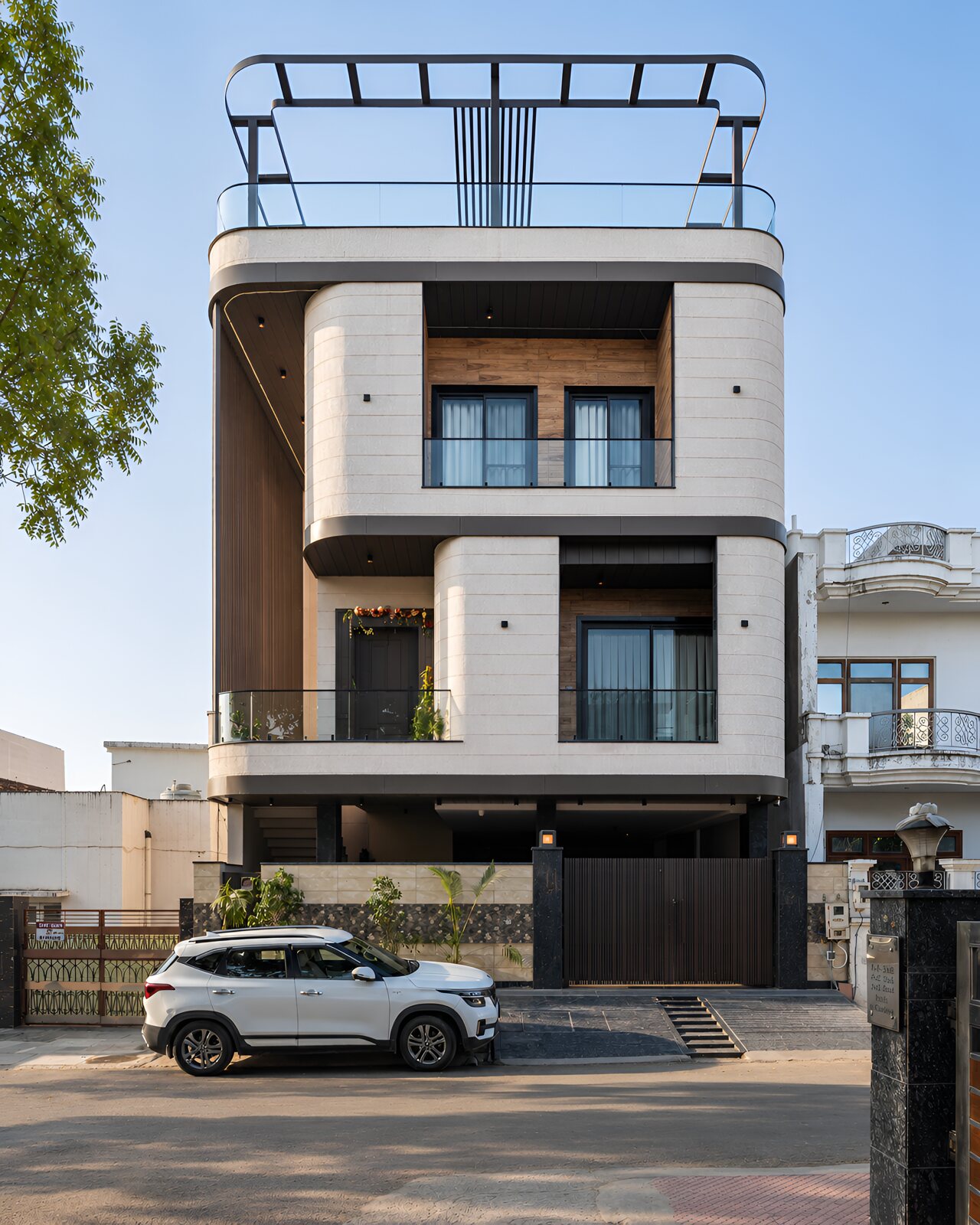 The elevation head-on, three floors of stone and glass.