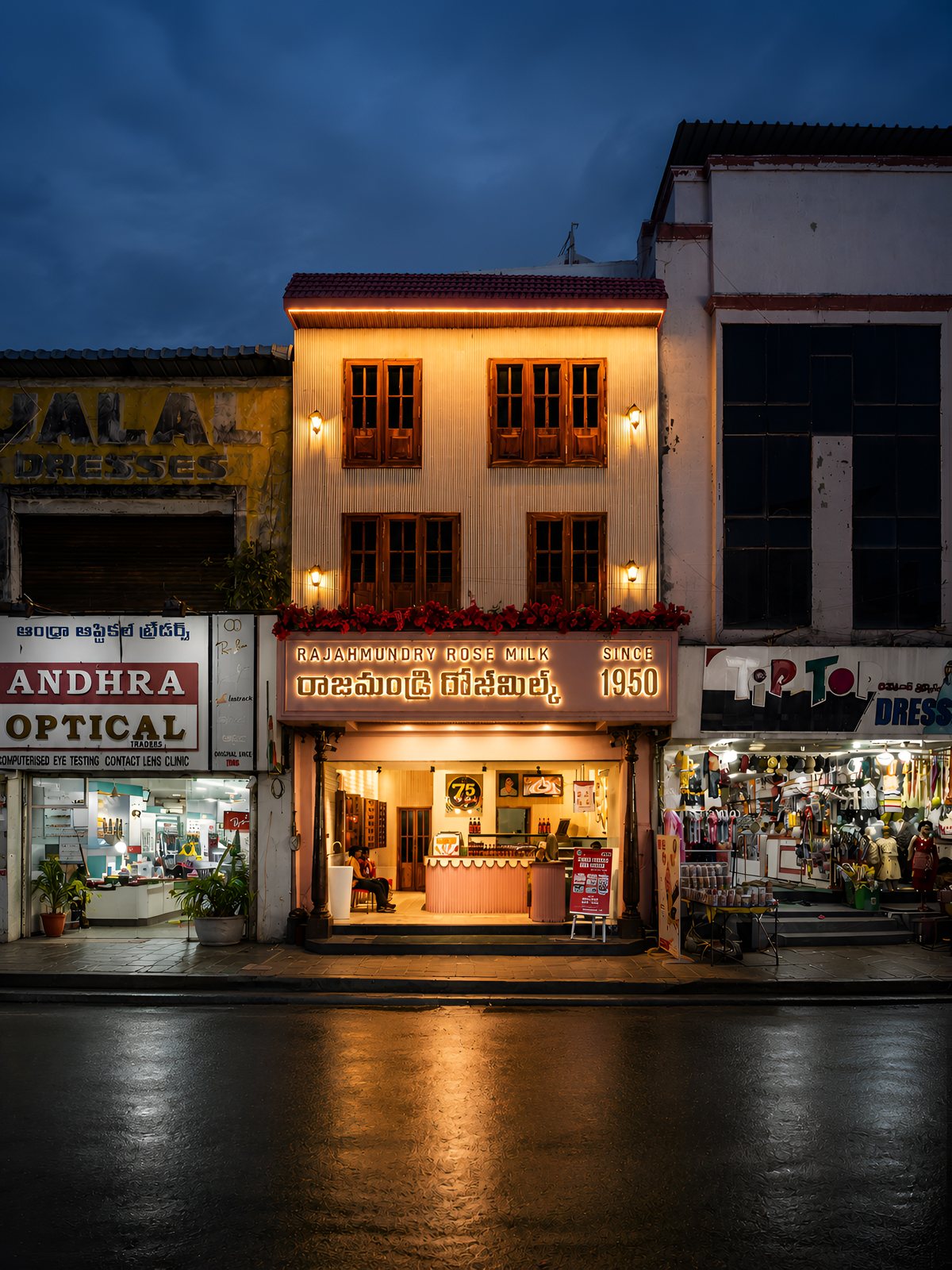 The same facade lit at night.
