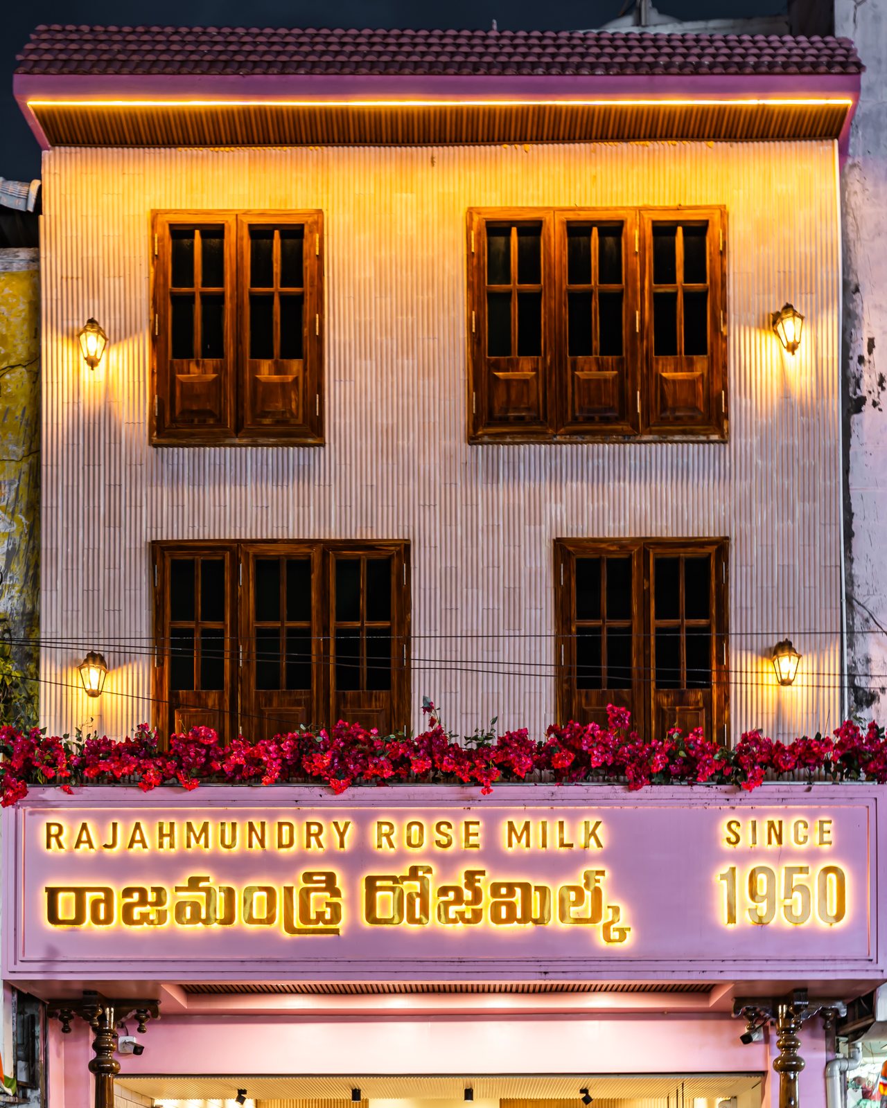 The glowing signboard and its bougainvillea.