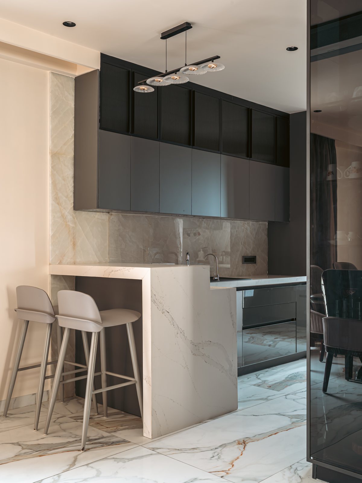 The kitchen, a marble island and dark cabinetry.