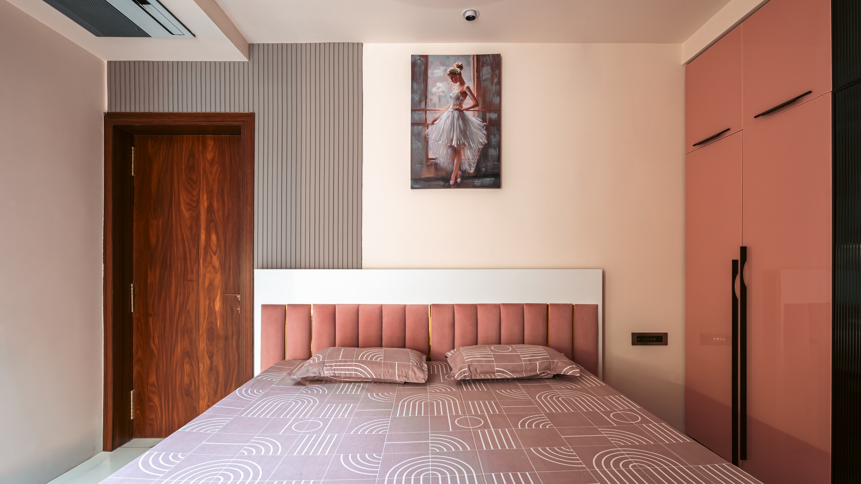 A bedroom in rose and walnut.