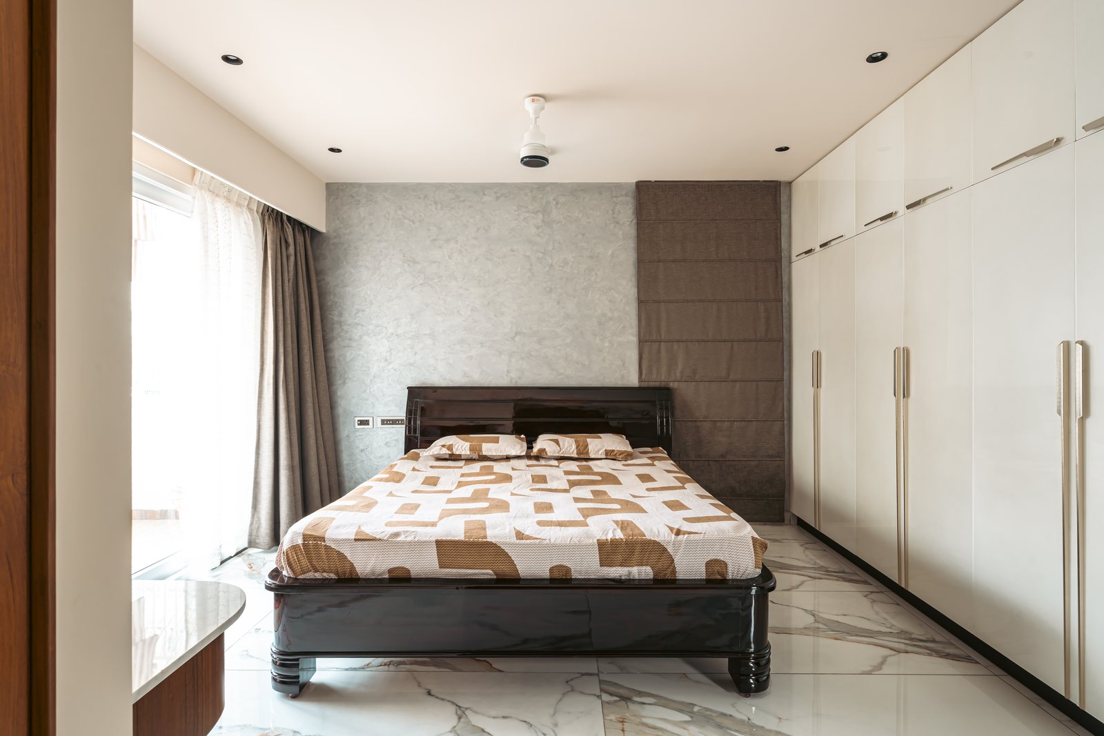 A quieter bedroom in cream and wood.