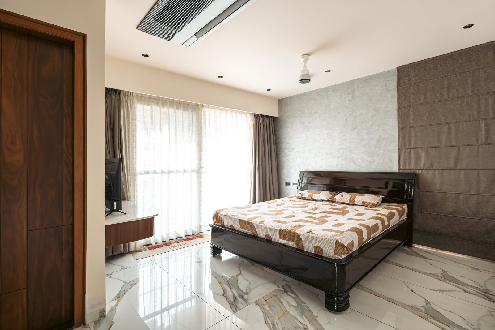 A dark-wood bed against textured stone.
