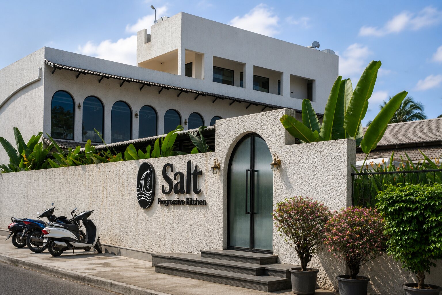 The white arched facade and the Salt sign by day.