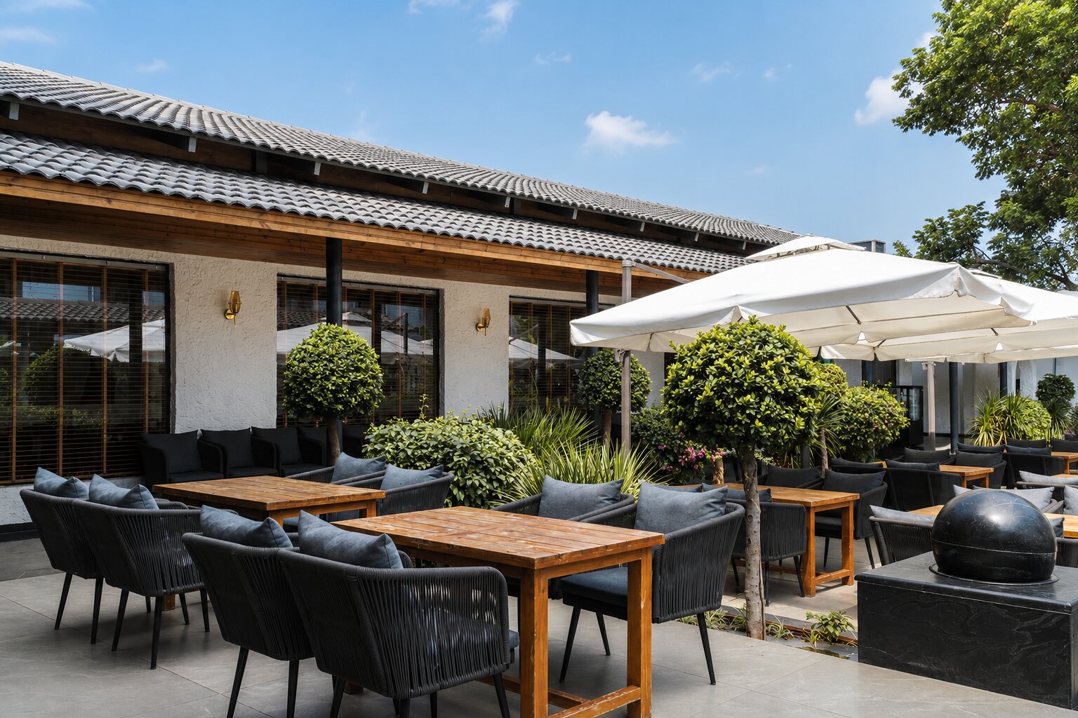 The courtyard terrace, tables in the sun.