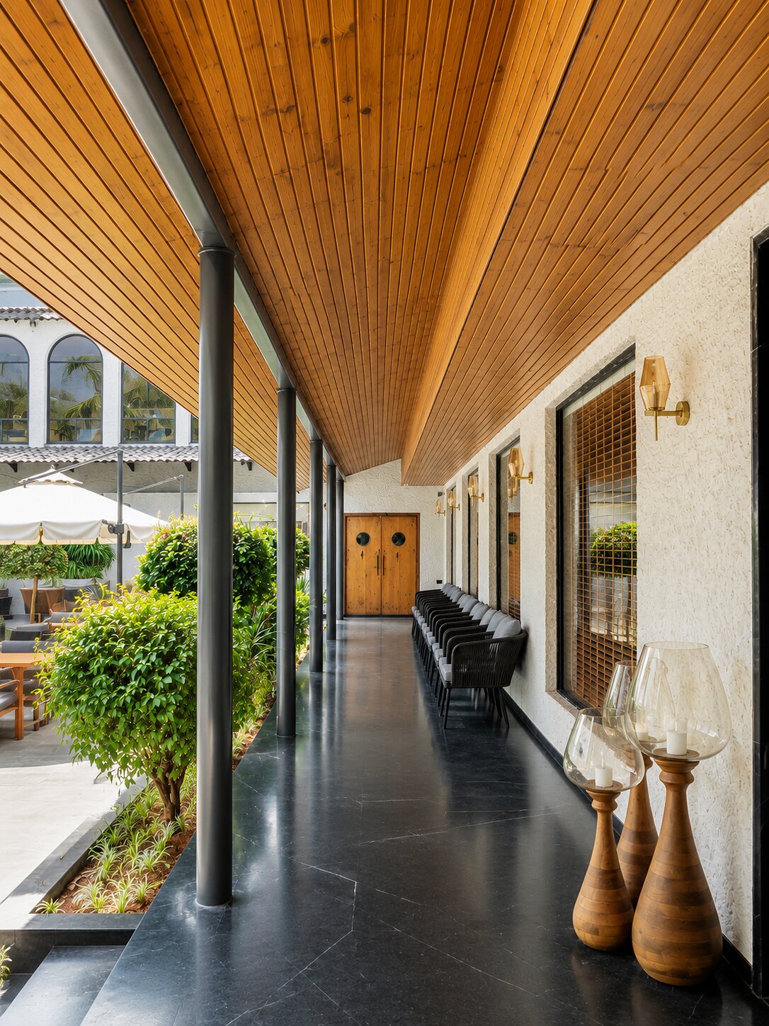 A covered walk, timber ceiling over the greenery.