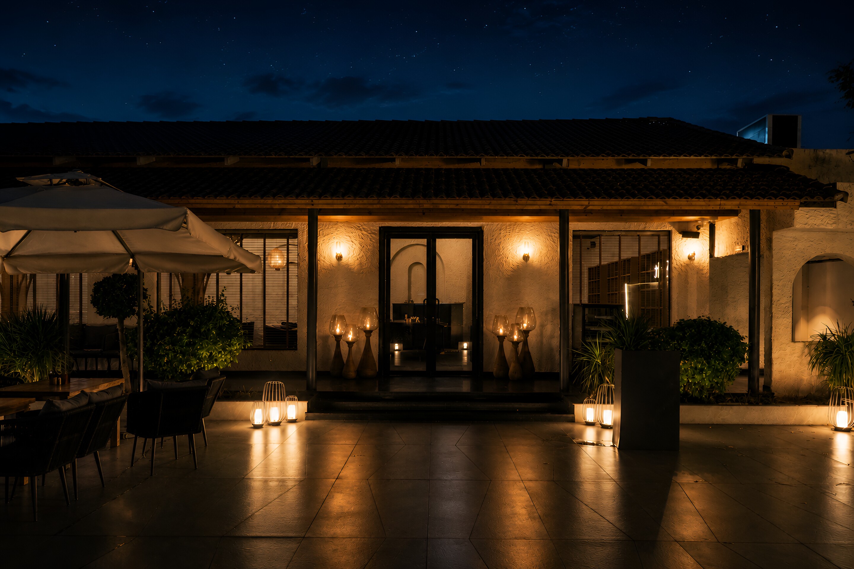 The terrace at dusk, candles set at the entrance doors.