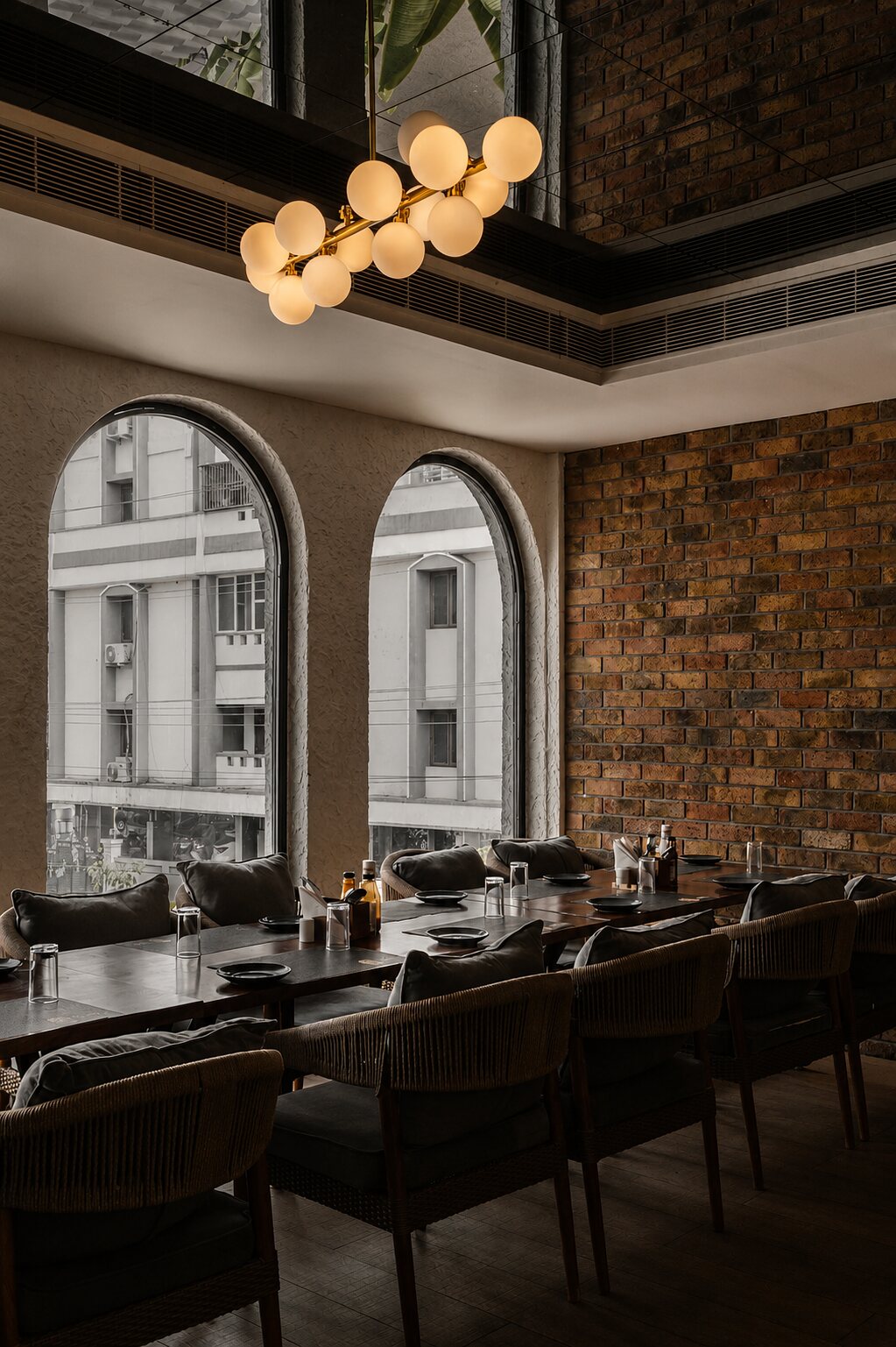A booth against exposed brick and an arch.