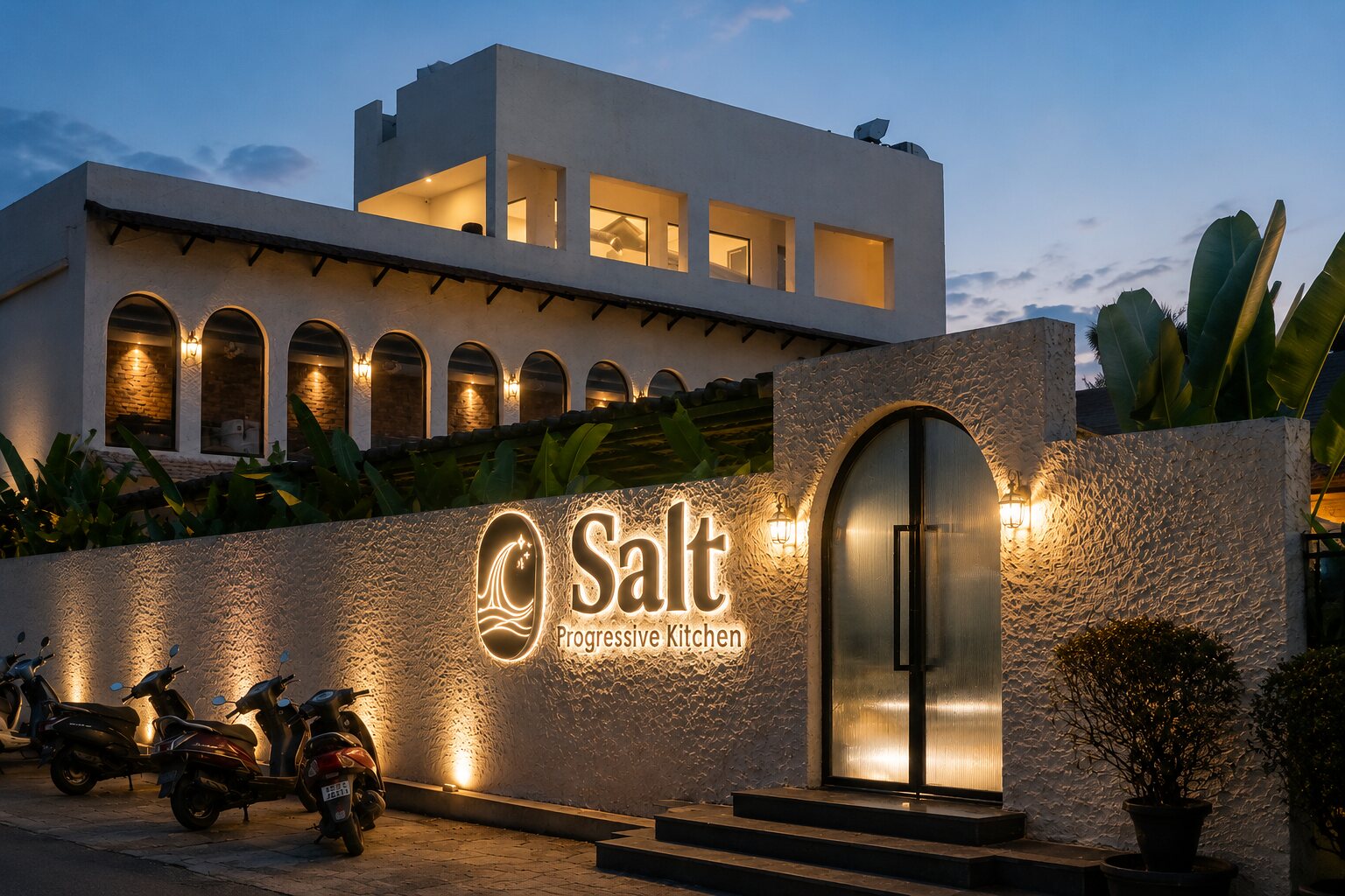 The facade at dusk, the sign lit.
