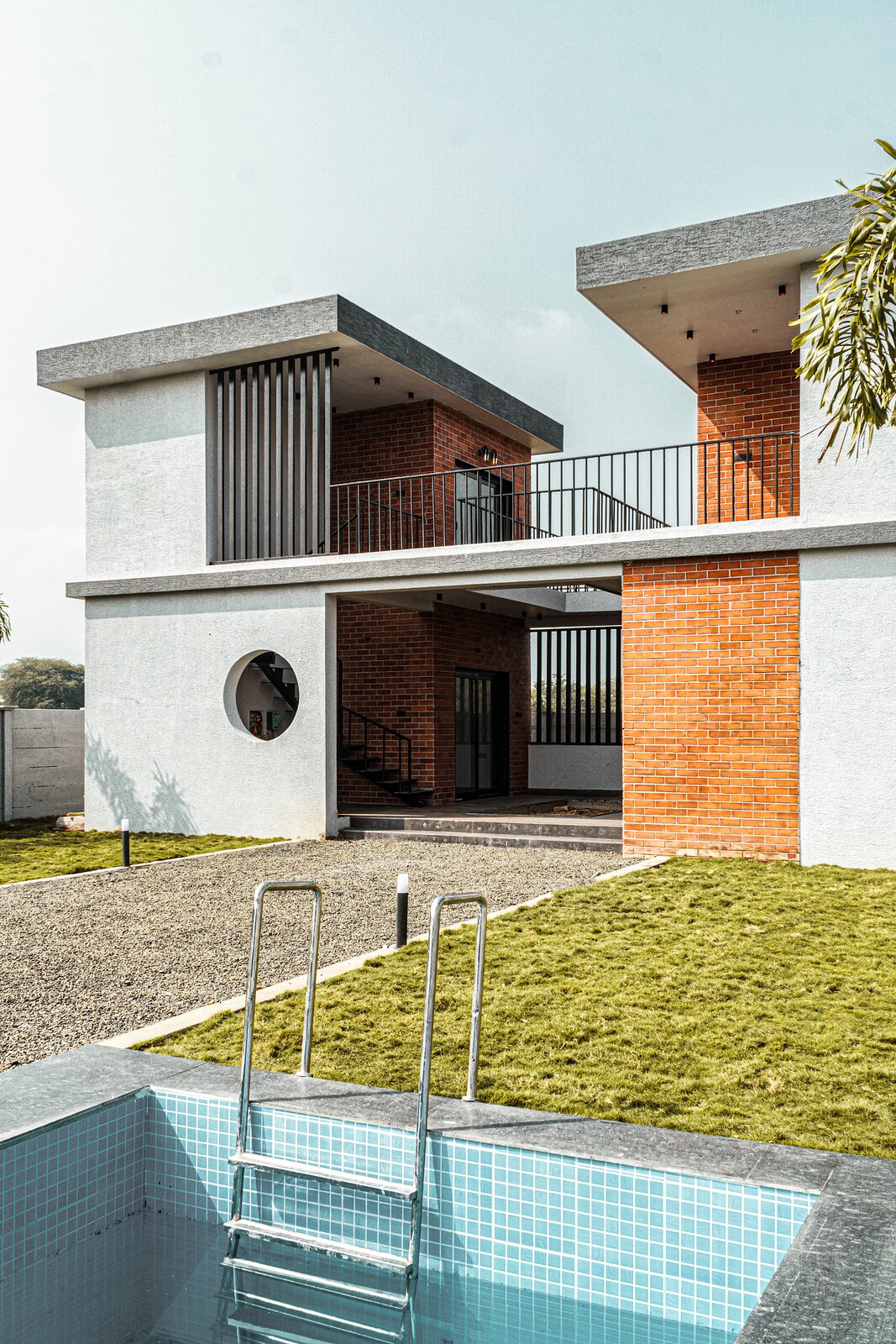 The pool along the white brick wall.